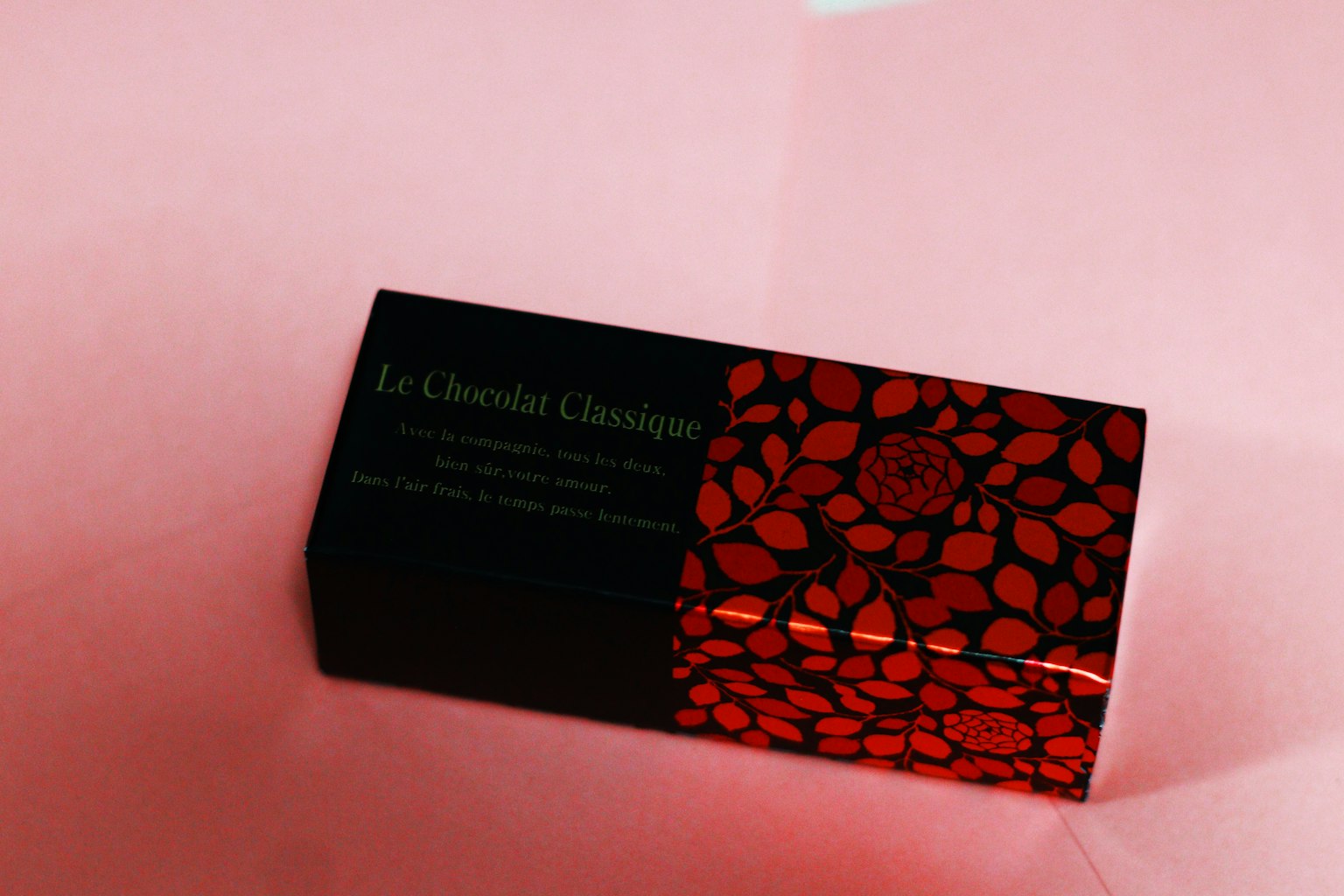 Emballage de chocolat avec un design floral noir et rouge