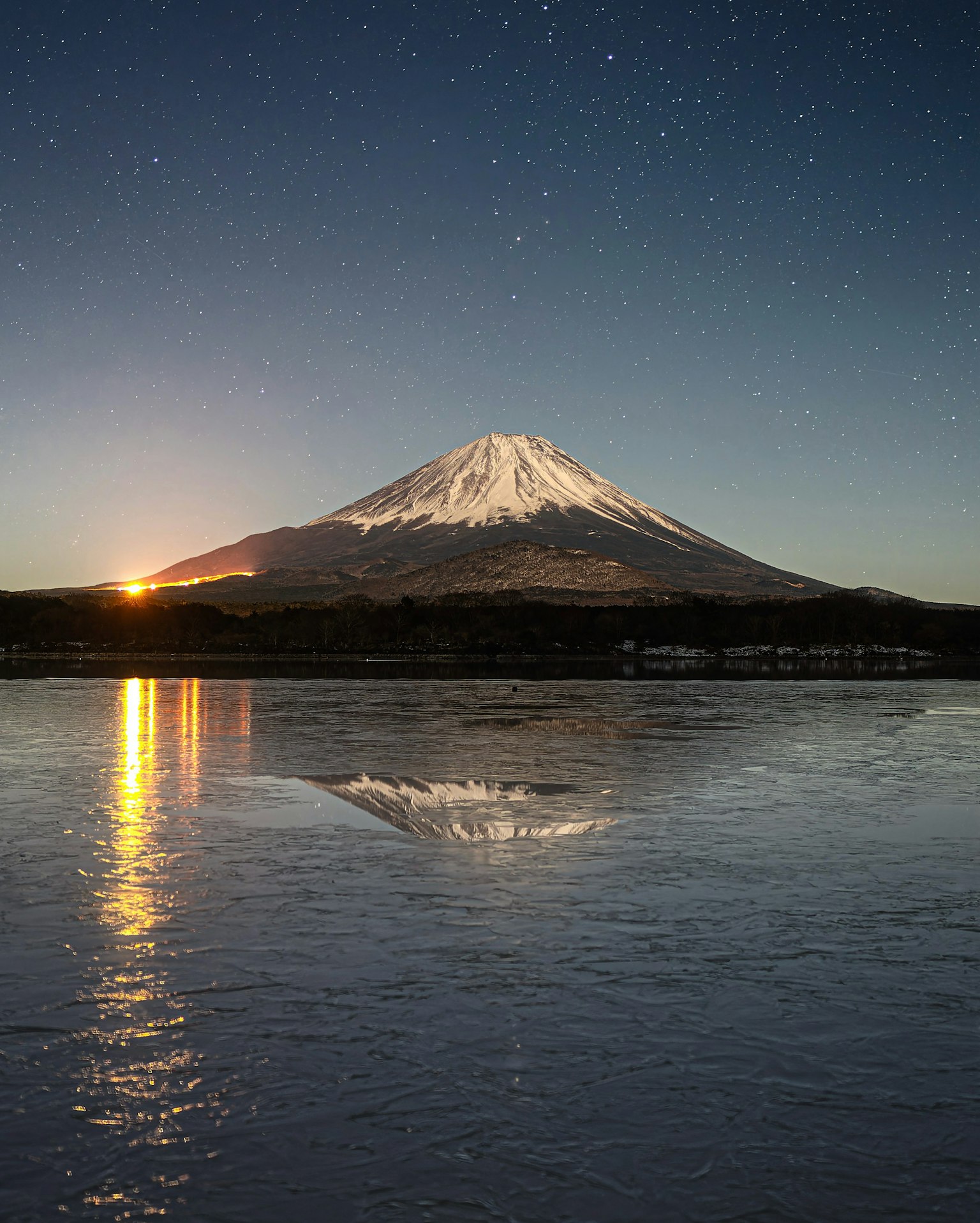 Mont Fuji la nuit avec un ciel étoilé se reflétant sur le lac
