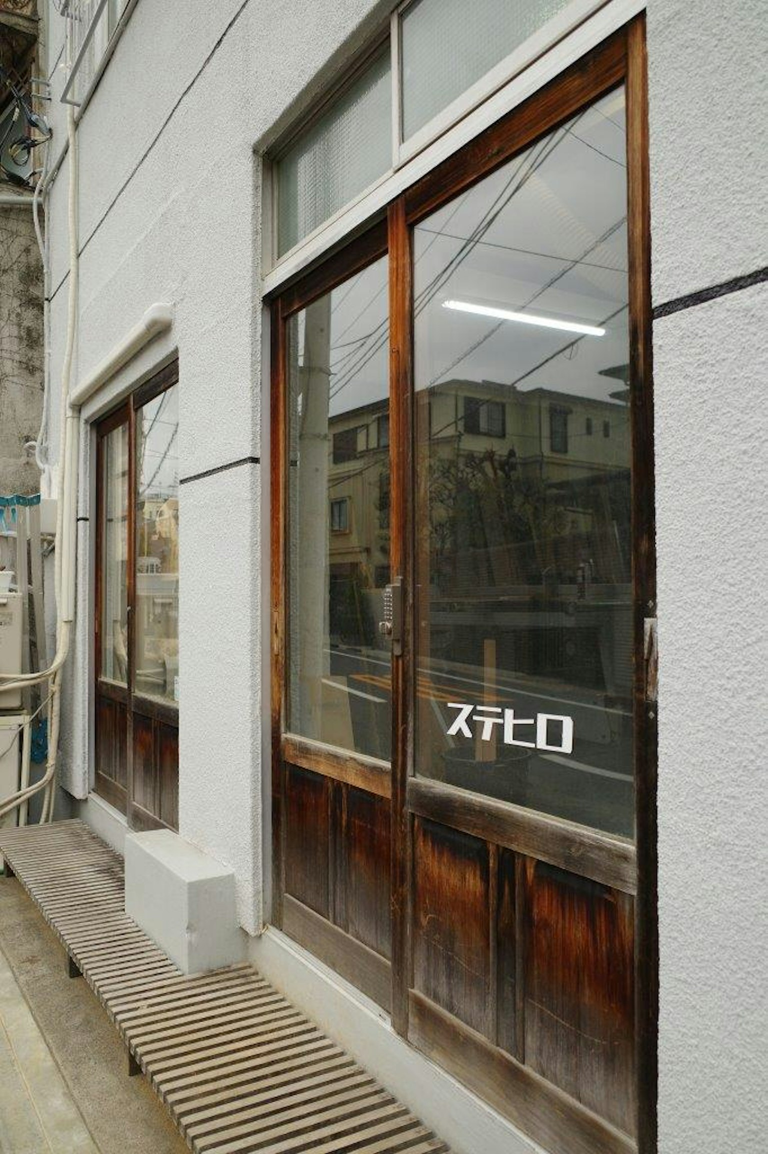 Storefront with wooden doors and windows prominent Stero sign