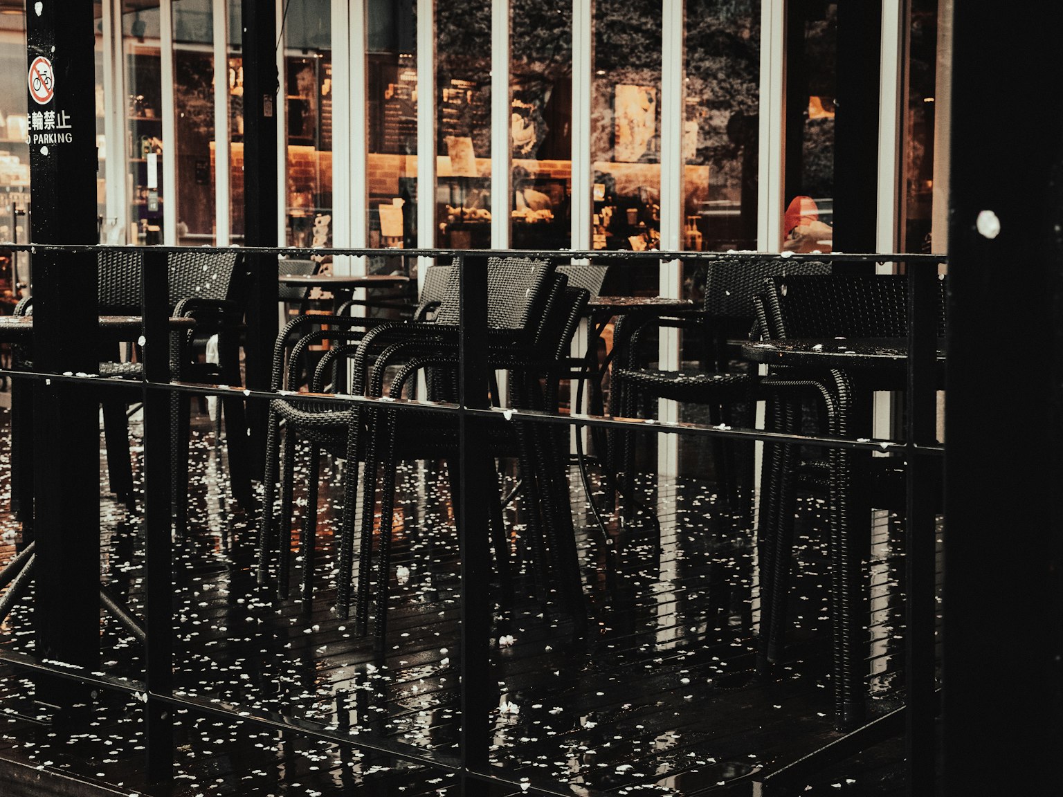 Outdoor café terrace with wet chairs and tables after rain