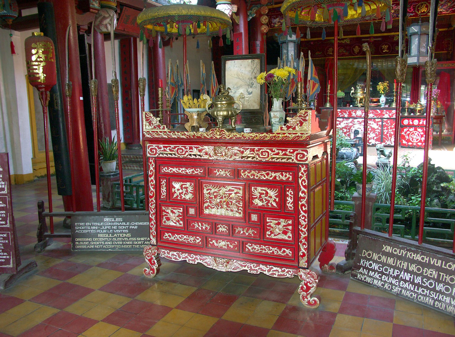 Interior of a temple featuring a decorative red altar