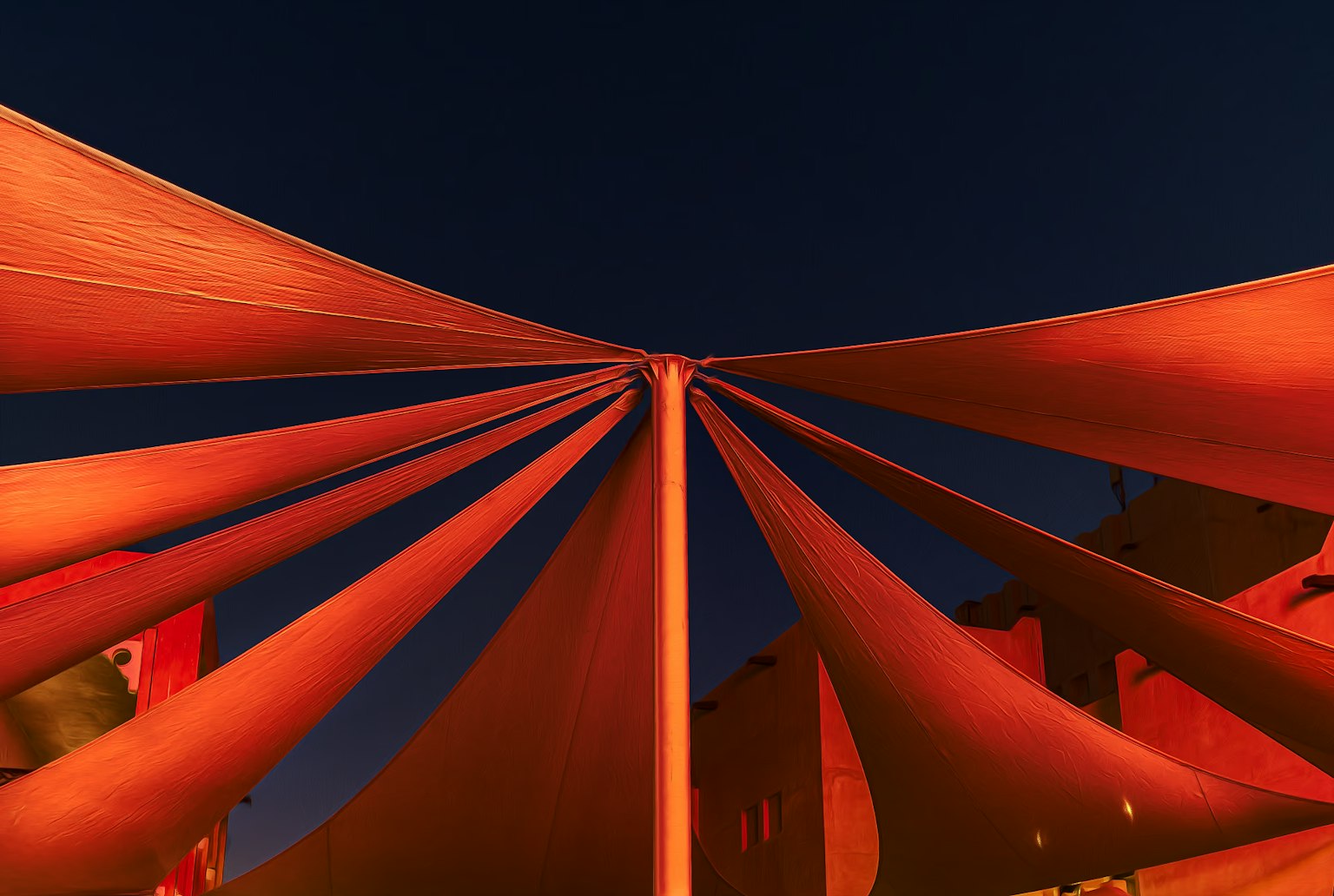 Radiating orange tent fabric against a night sky