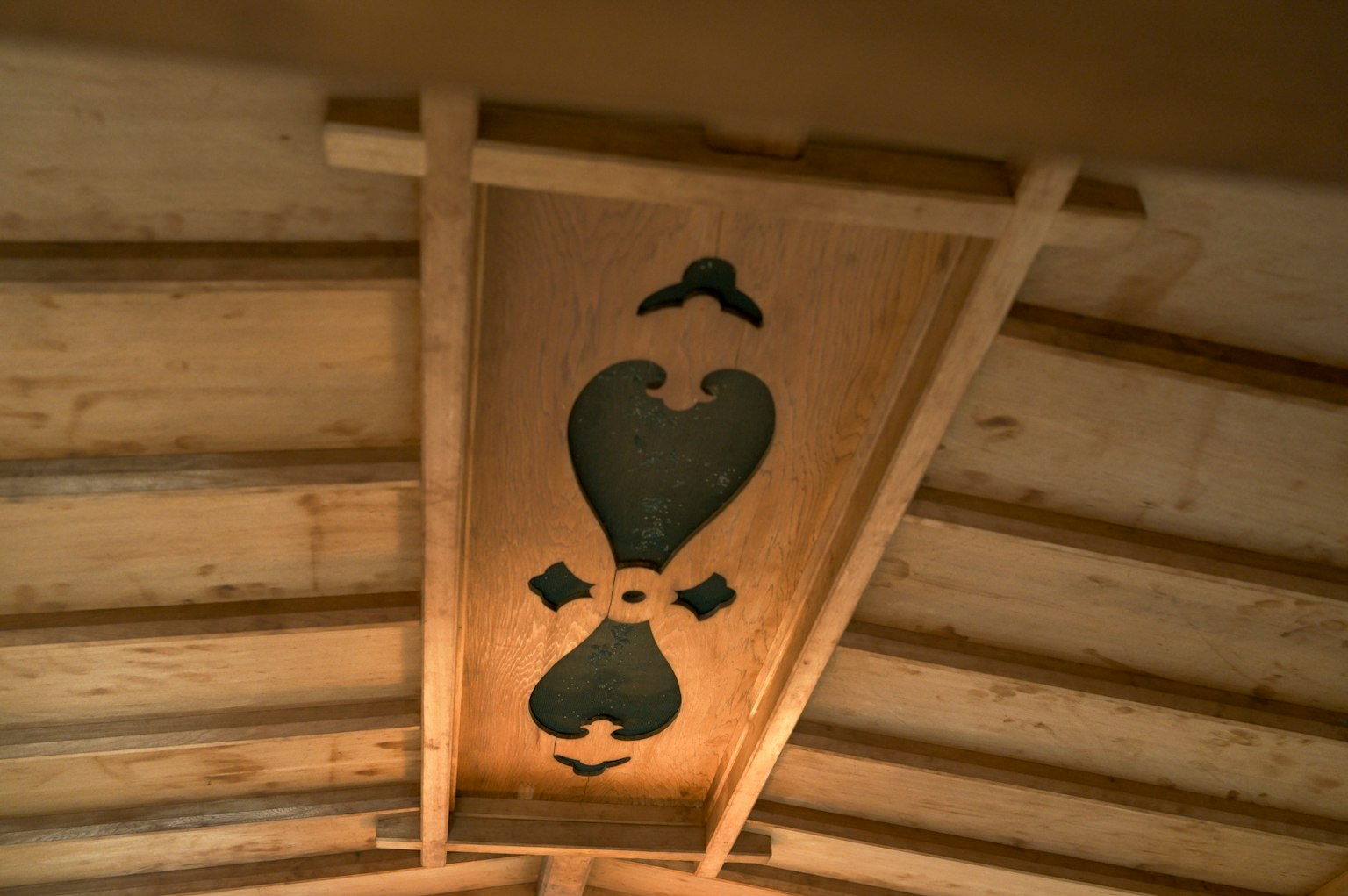 Decorative design on a wooden ceiling featuring a heart shape