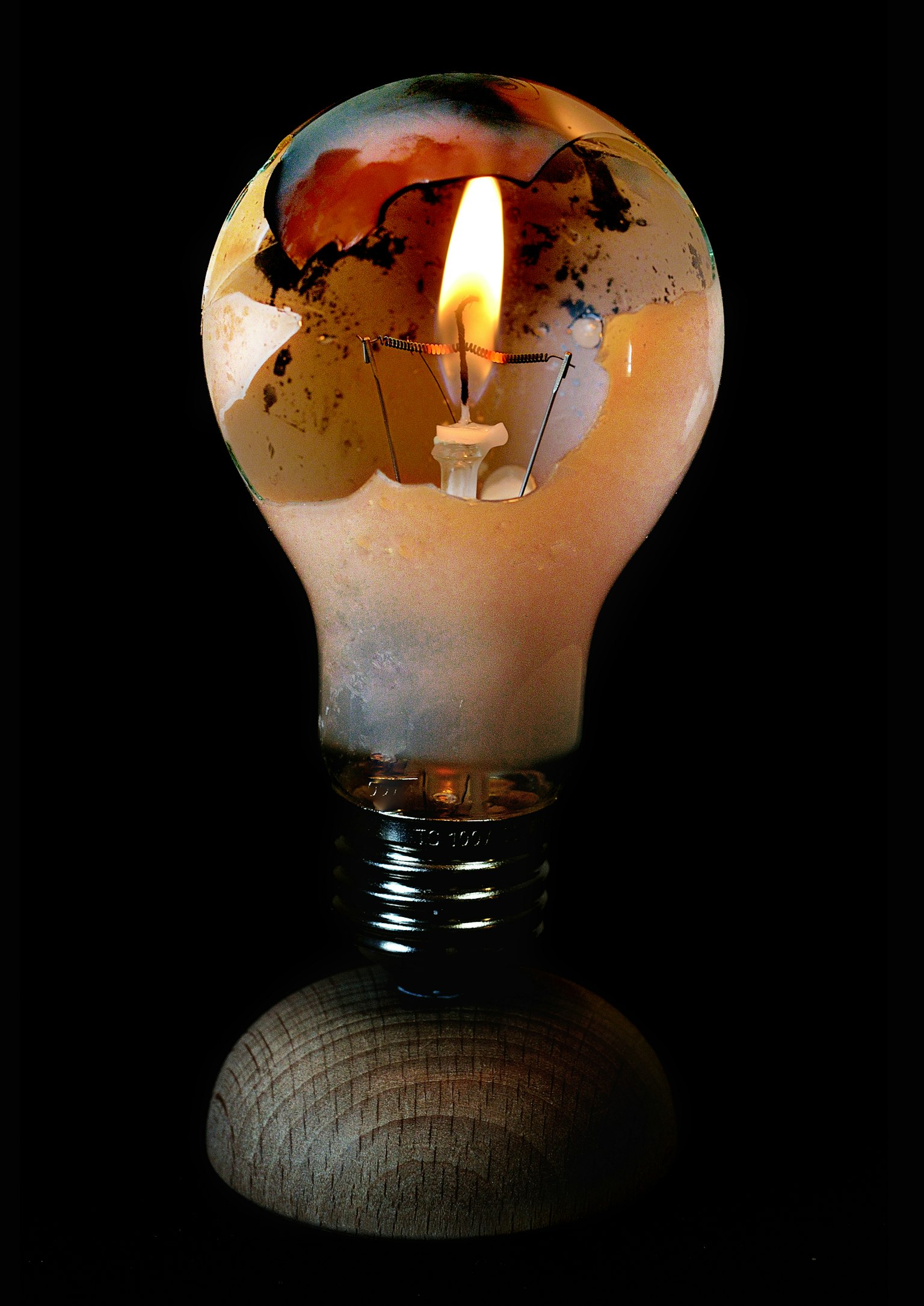 Unique candle shaped like a light bulb with flame