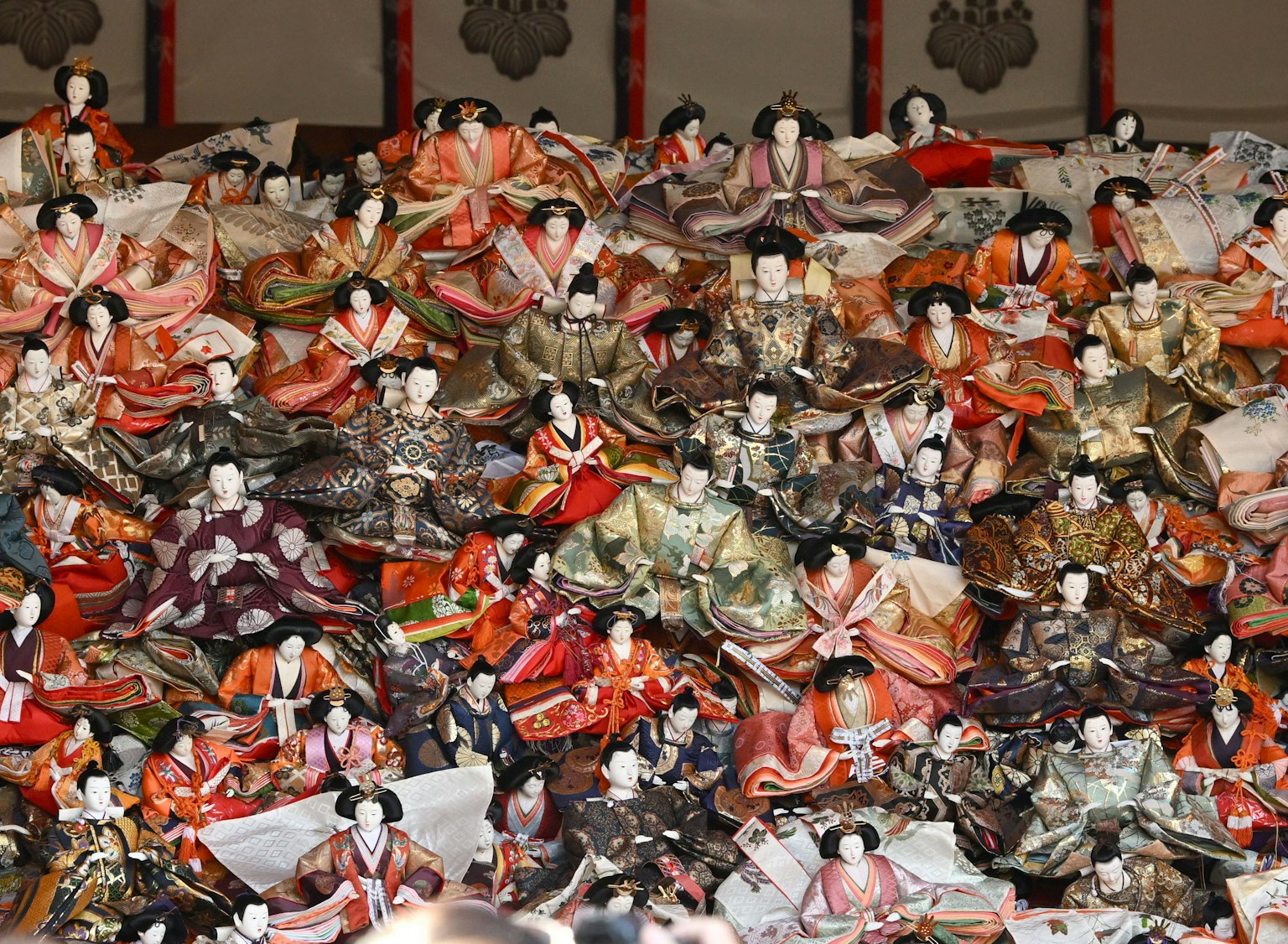 Colorful hina dolls dressed in traditional kimonos arranged in a vibrant display