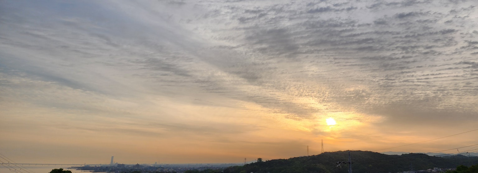 Landscape with a sunset and striped clouds