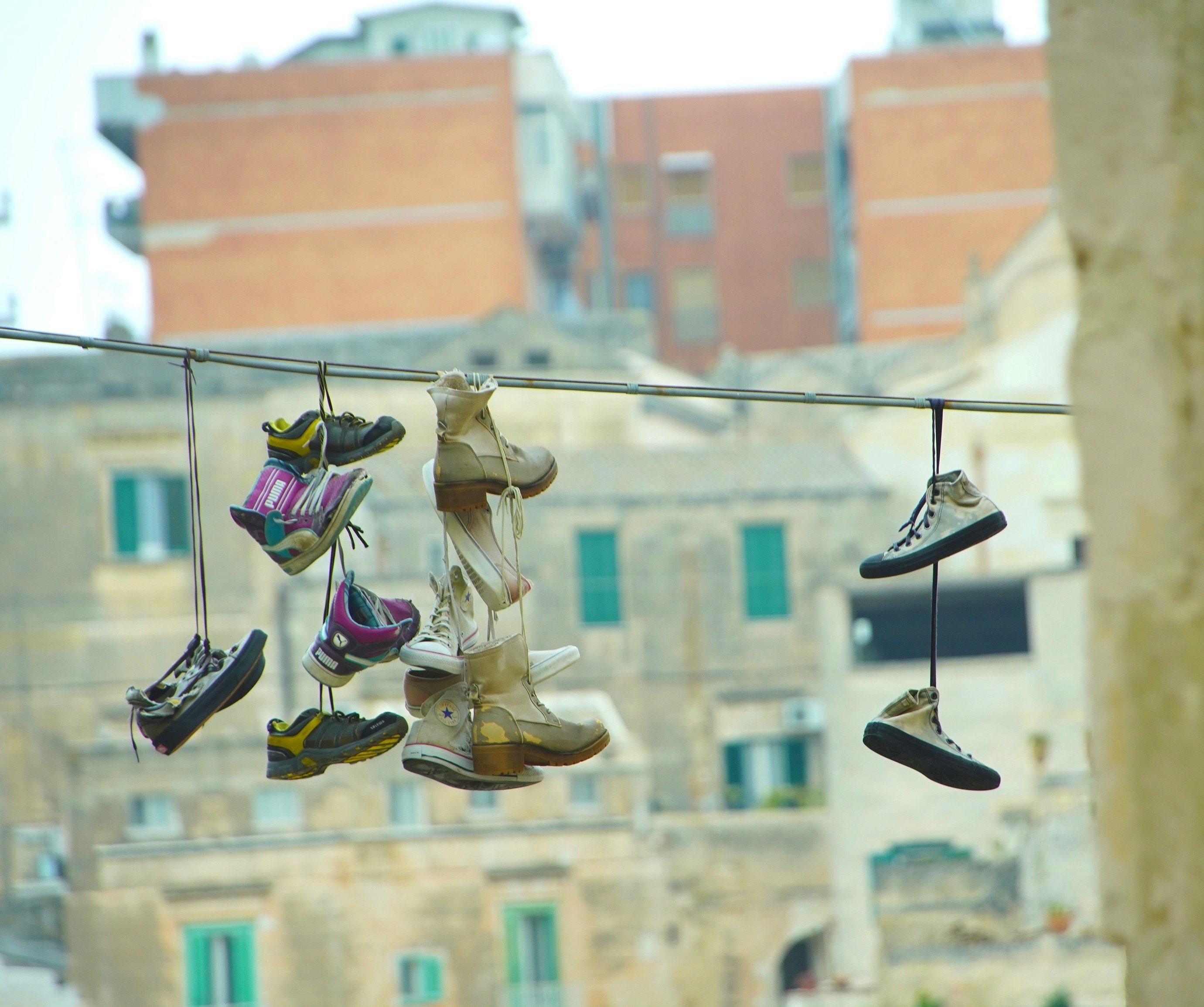 Street scene with shoes and sneakers hanging like laundry