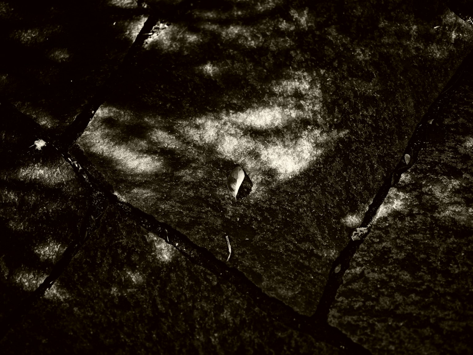 Jalan batu gelap dengan bayangan yang jatuh