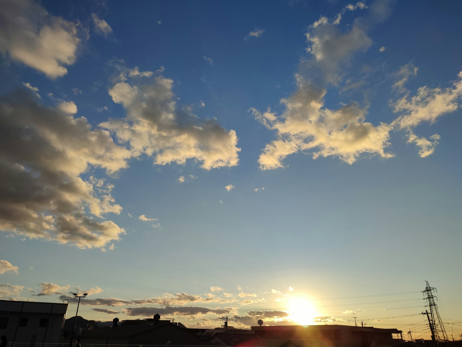 Scenic view of a blue sky with white clouds and a sunset
