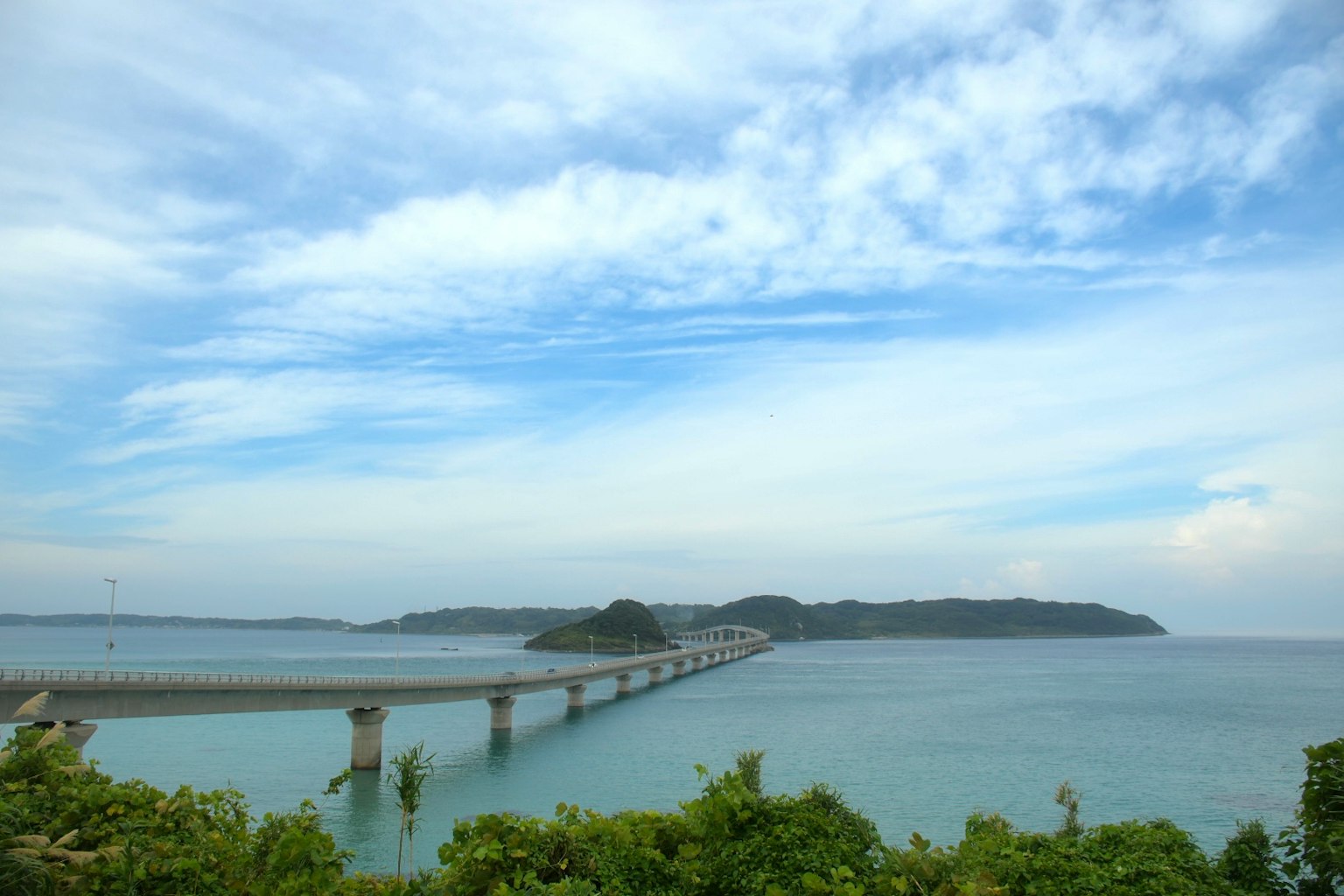 ทิวทัศน์สวยงามของสะพานที่ทอดยาวเหนือผิวน้ำพร้อมเกาะในพื้นหลัง