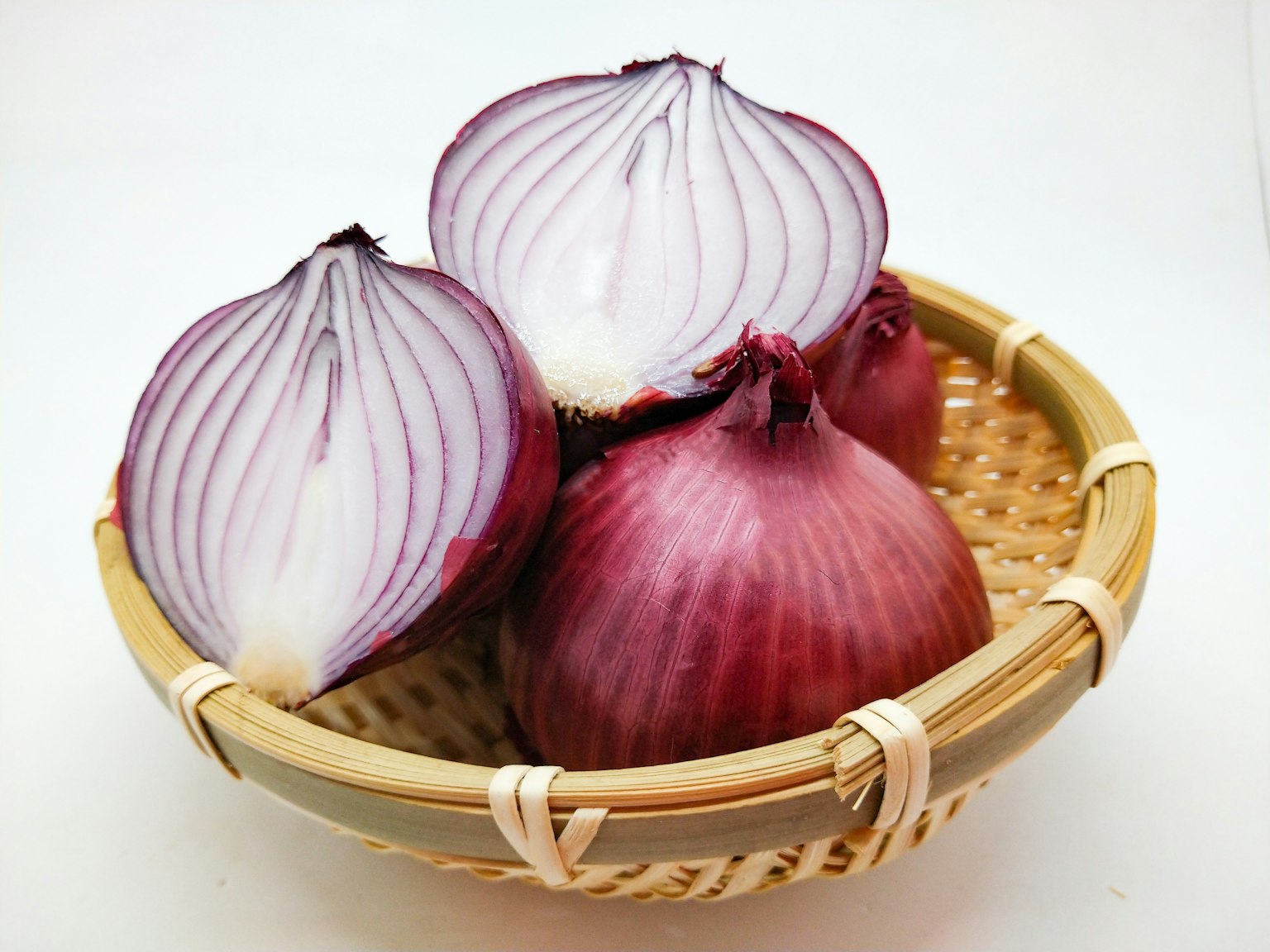 Red onions in a bamboo basket