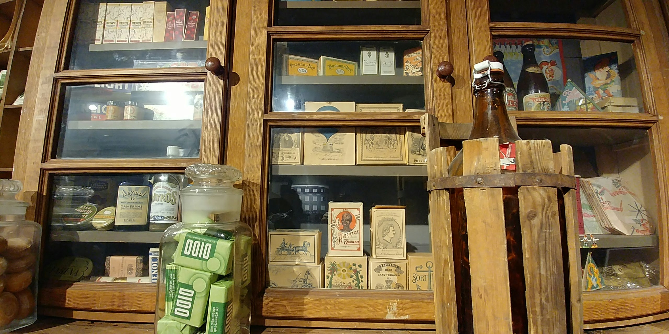 indoor shop display with wooden shelves of packaged goods and jars