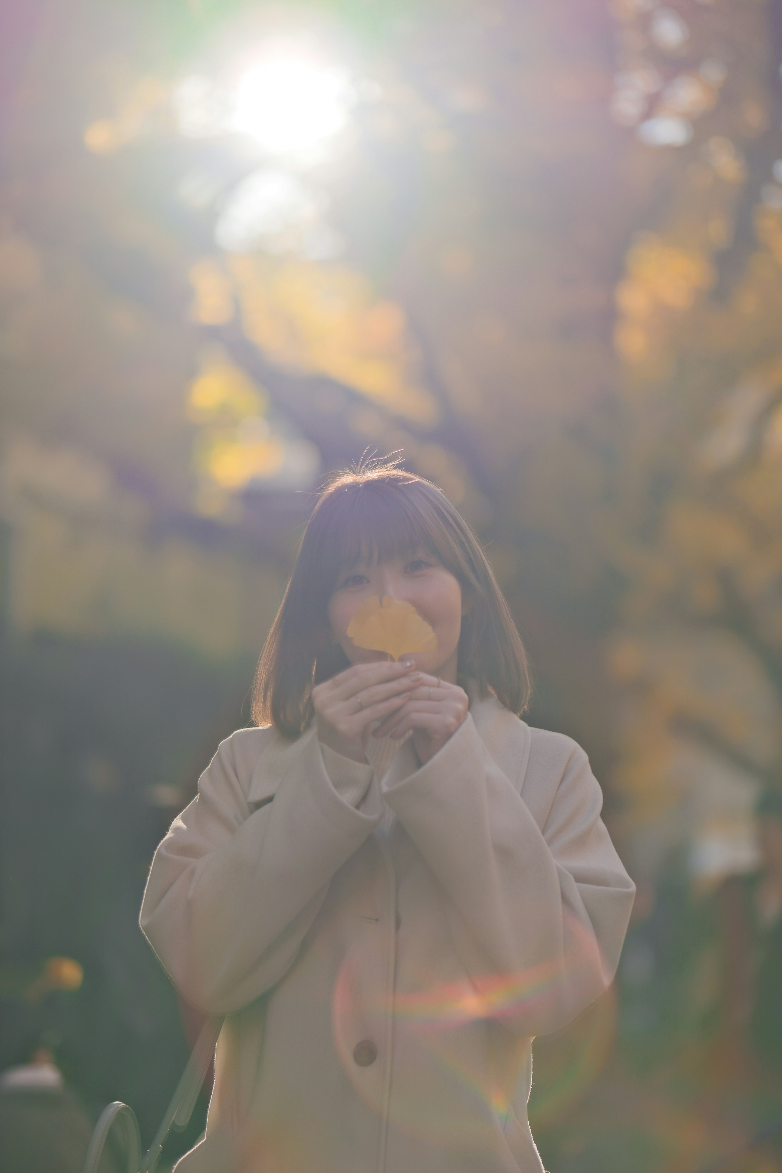woman smiling outdoors in soft sunbeams