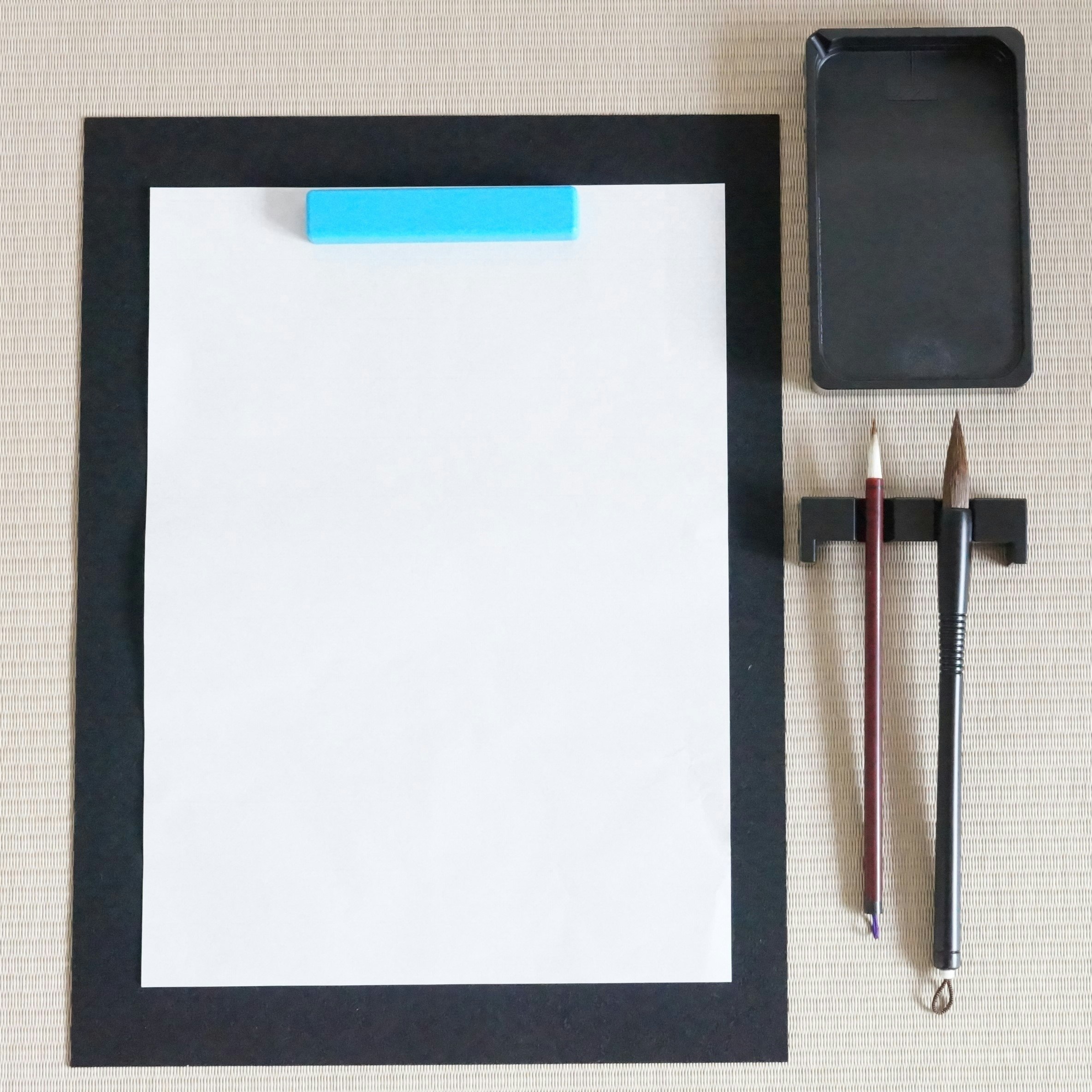 white paper sheet and pens on a desk