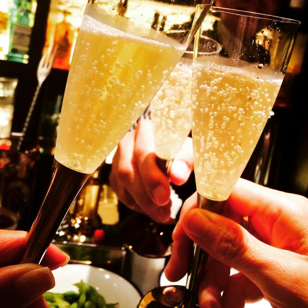 cheers with champagne flutes and bubbles
