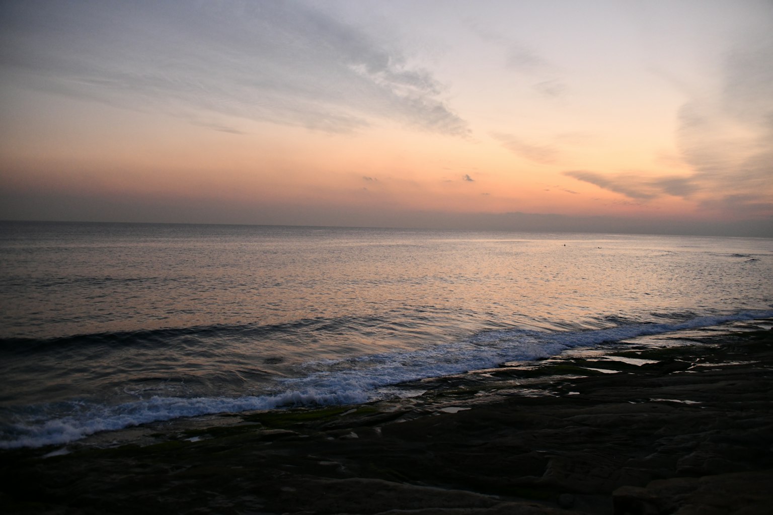 Coastal sunset view with rocks and waves