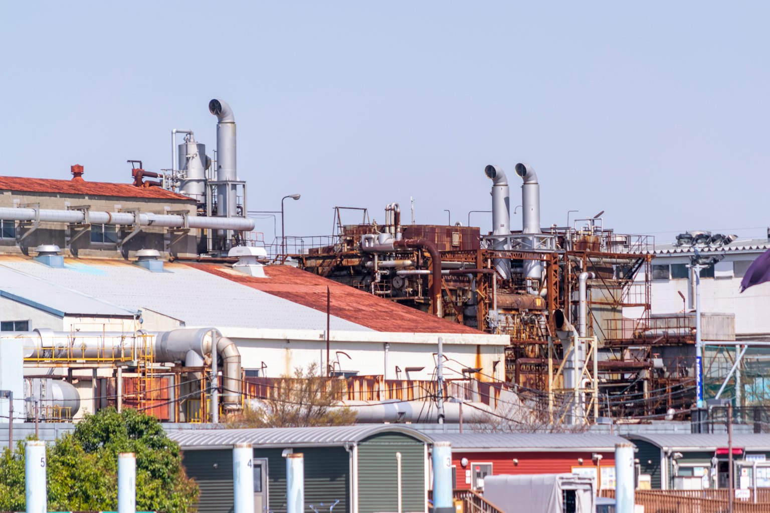 Industrial area featuring complex structures and smokestacks