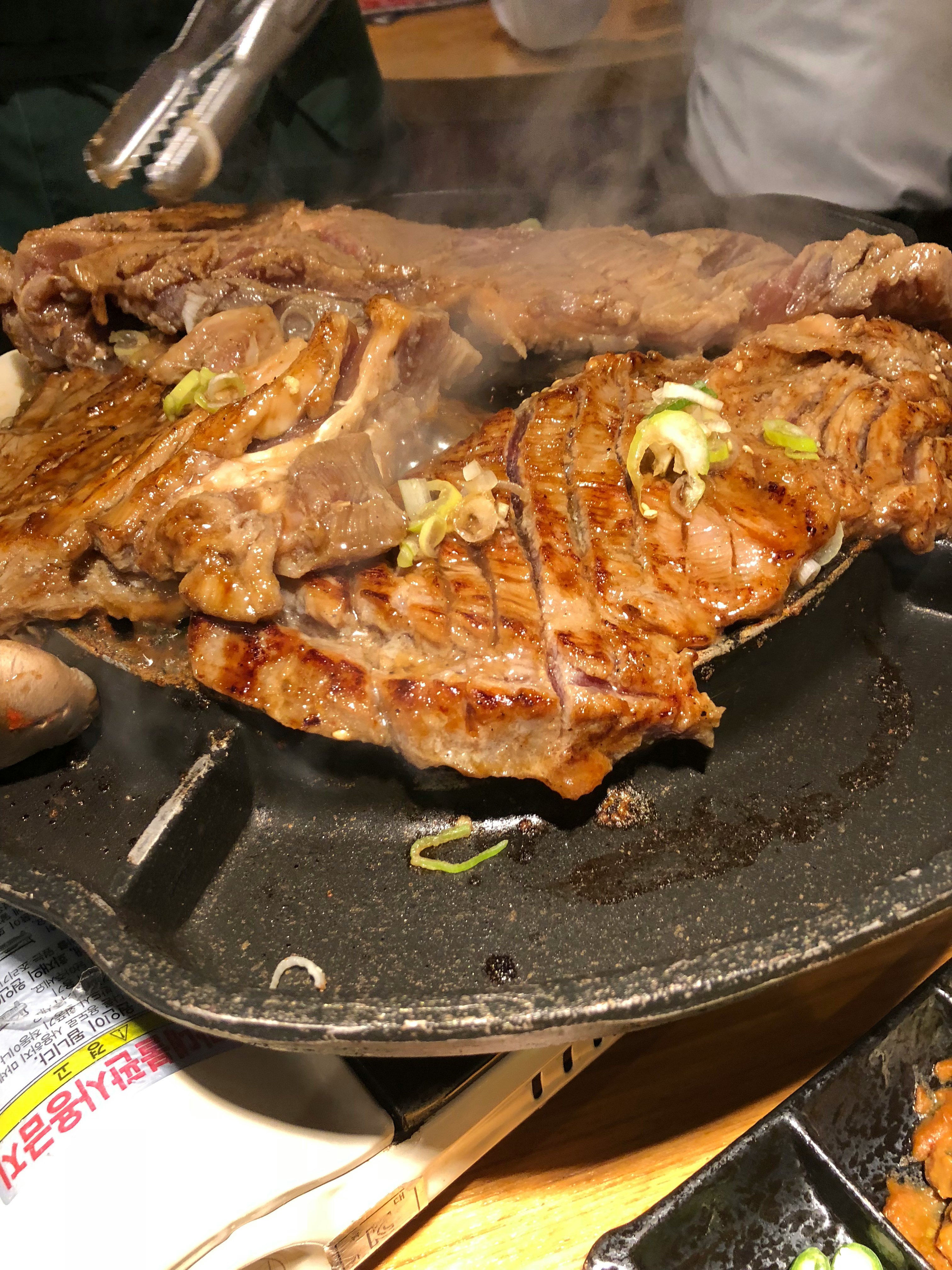 sizzling steak on a hot griddle