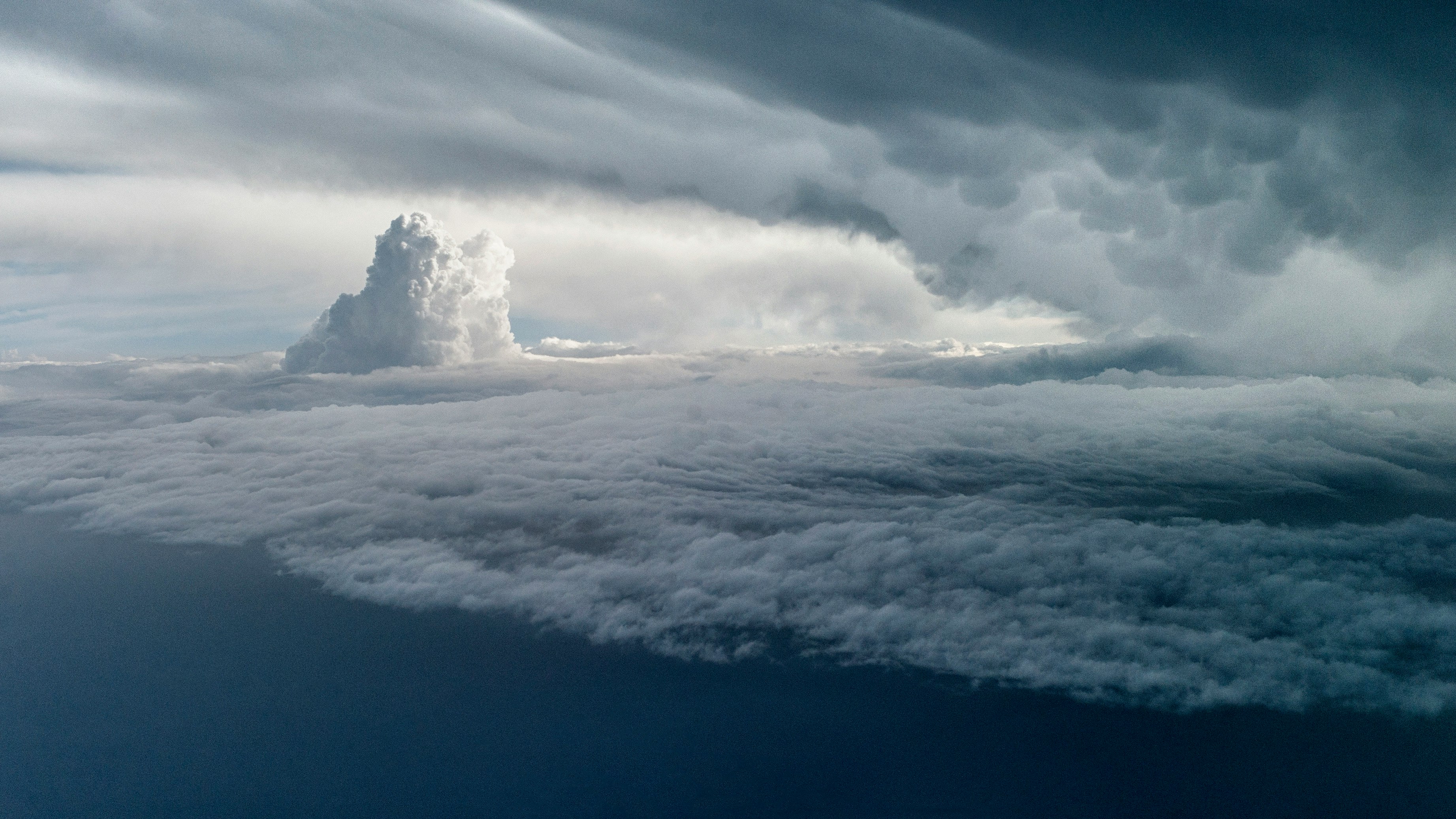 厚い雲層の上にそびえる積乱雲の嵐の空