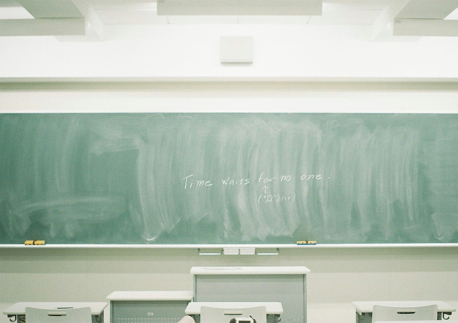 classroom learning space with a chalkboard and desks