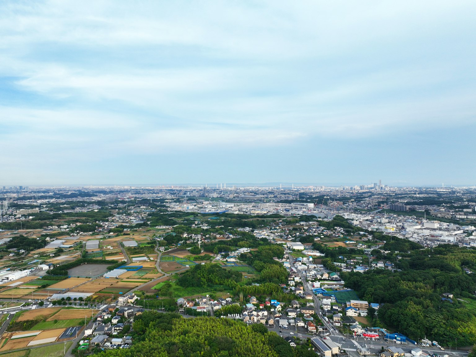 Vista aérea que muestra un vasto paisaje con áreas urbanas y campos