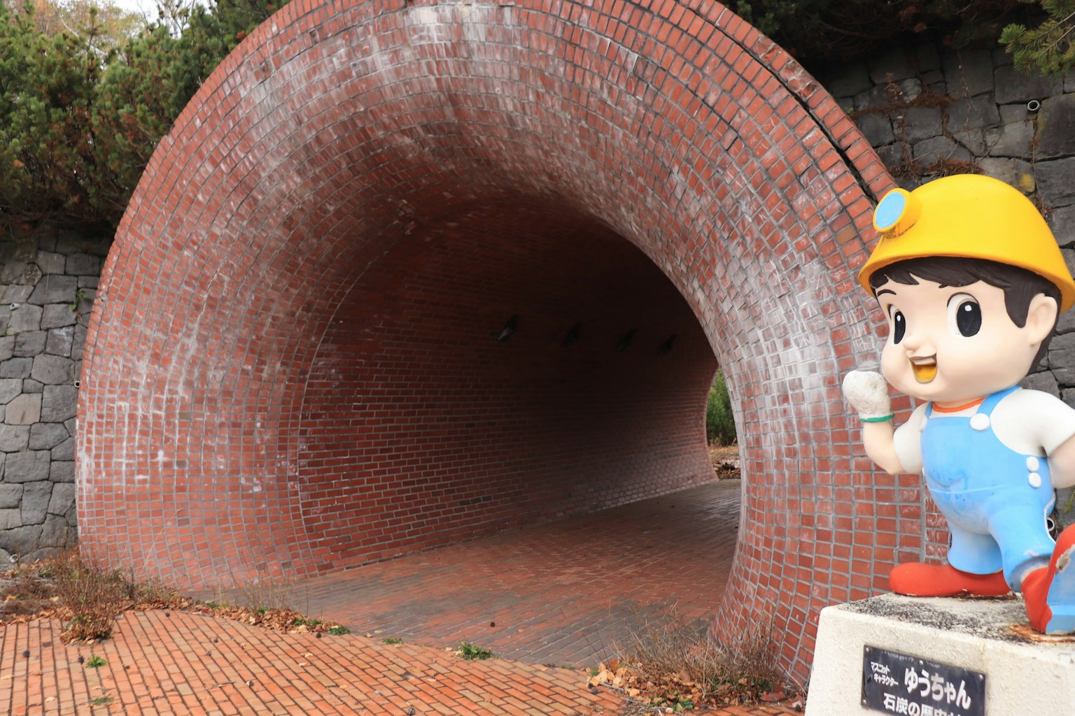 Brick tunnel with a character statue on the side