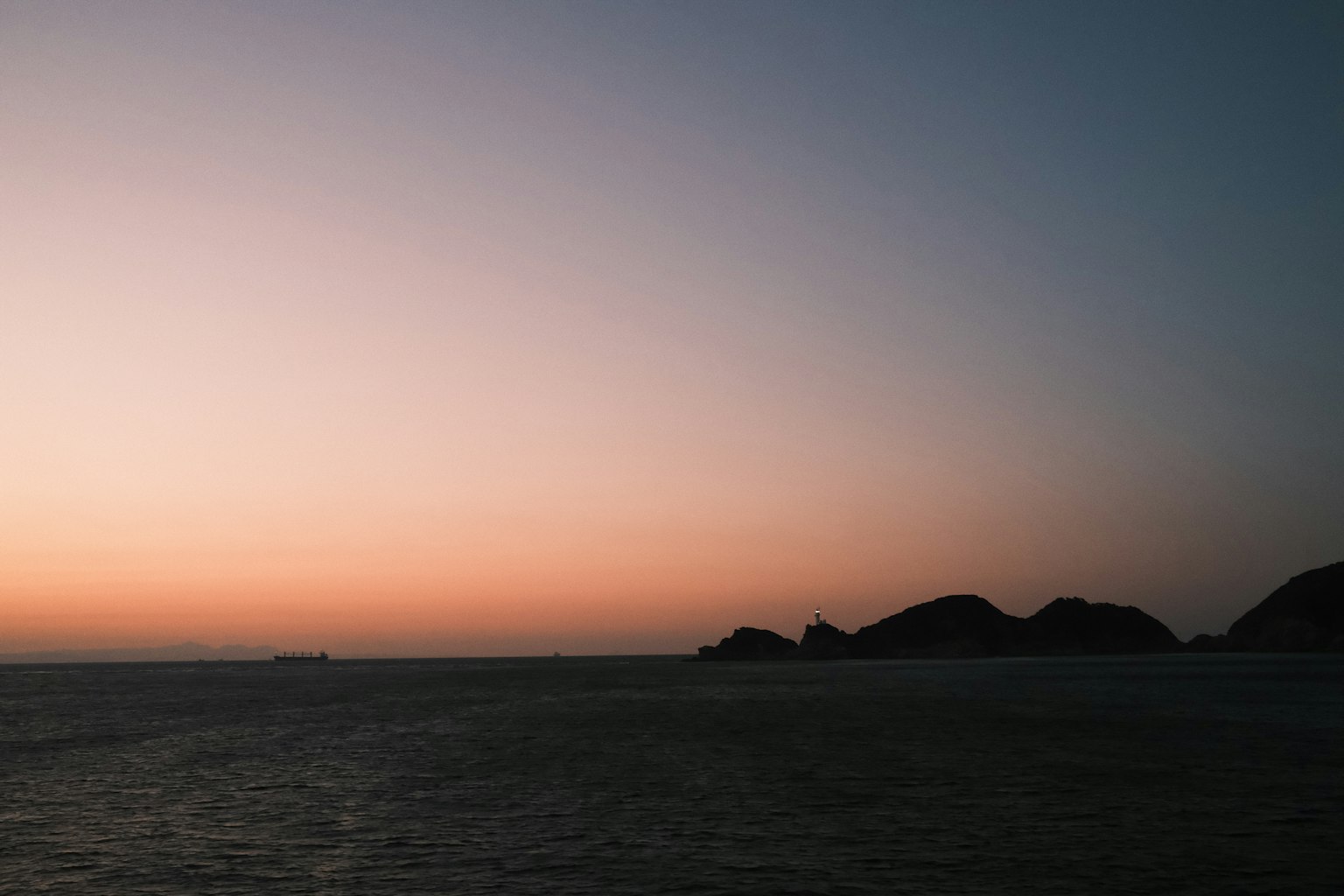 Beautiful sunset landscape with a calm sea and distant islands