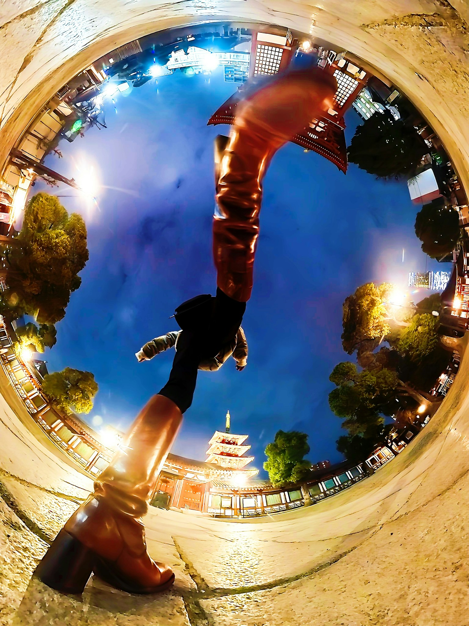 Unique perspective of a person's feet in a city at night