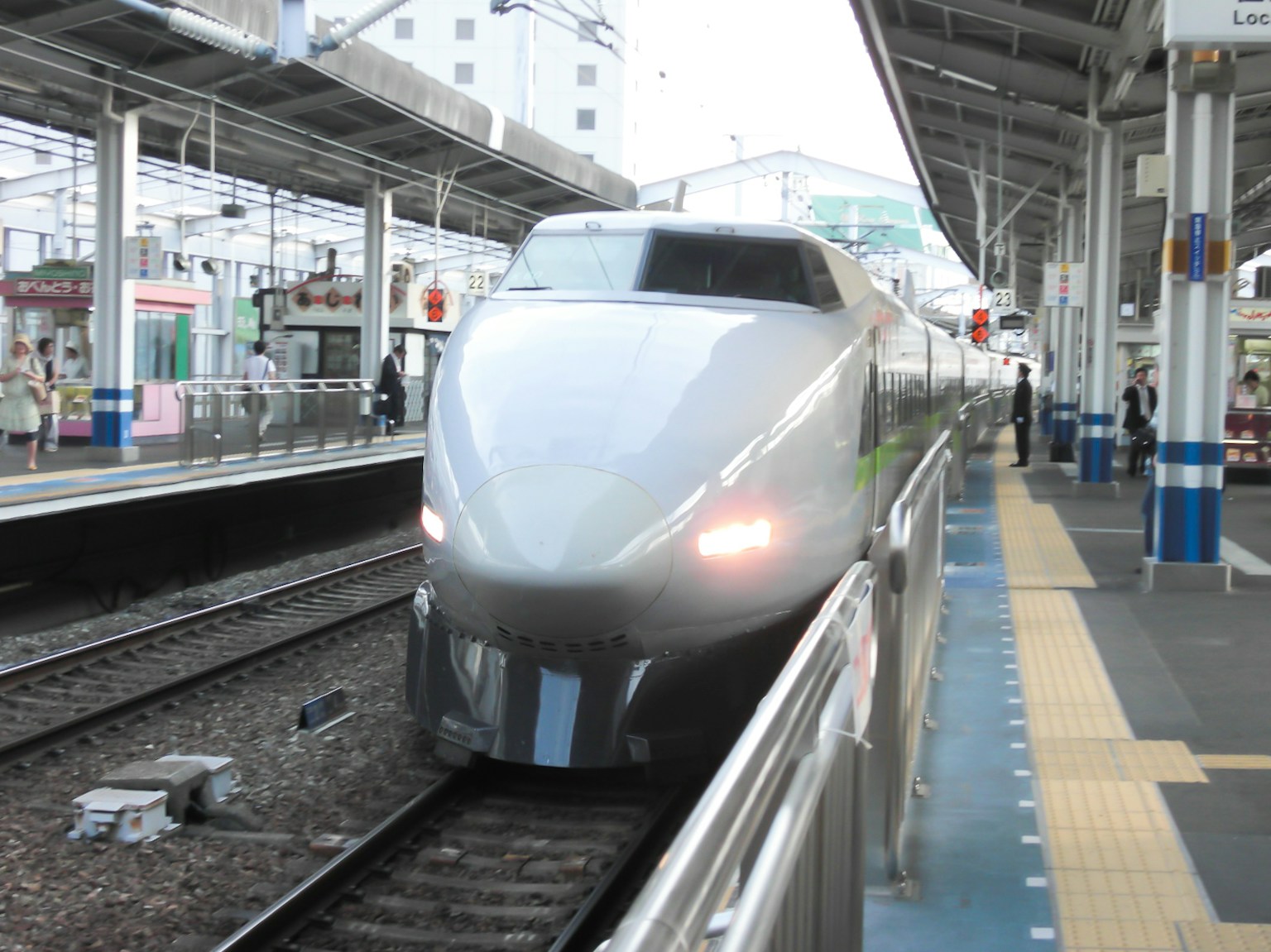 新幹線が駅に到着したシーン 鉄道とプラットフォームが写っている