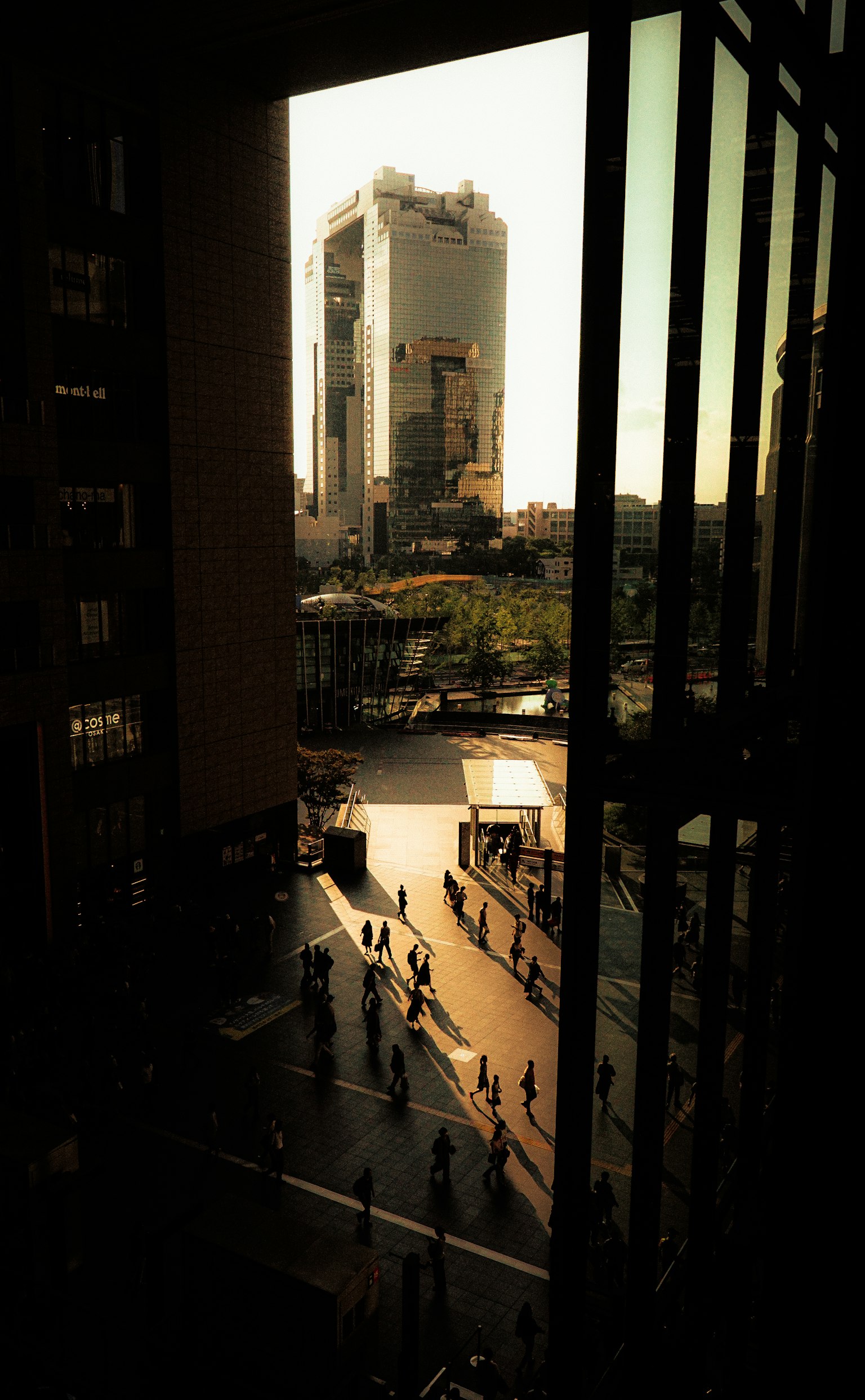 View of a skyscraper with people walking in the foreground