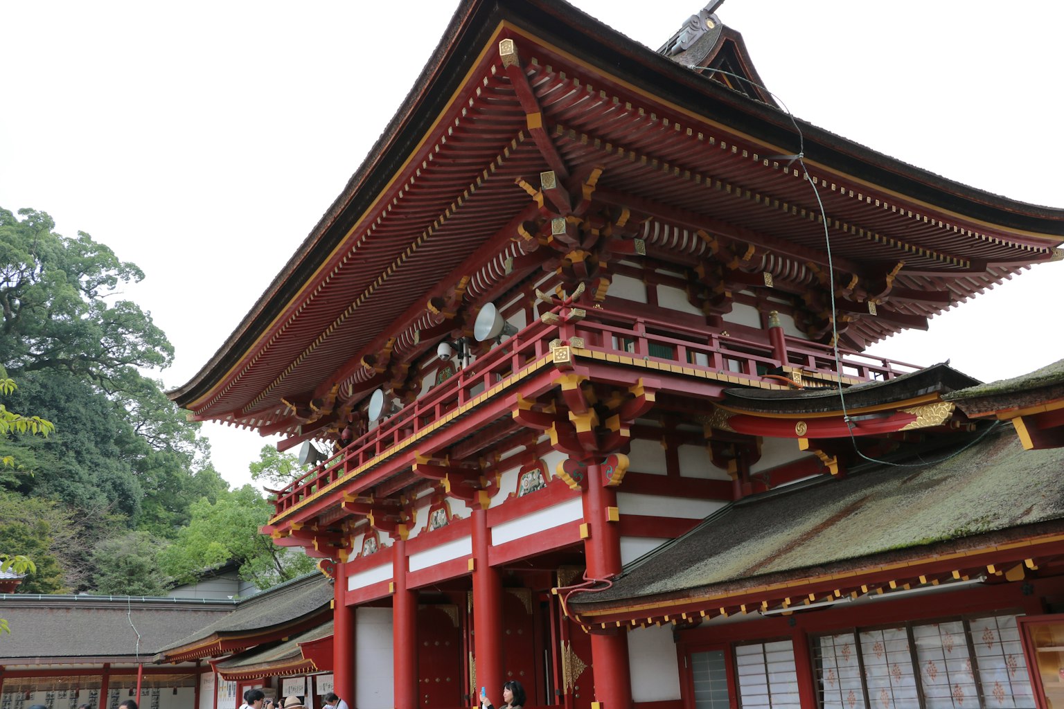 Traditional Japanese shrine building with a red roof and intricate architecture