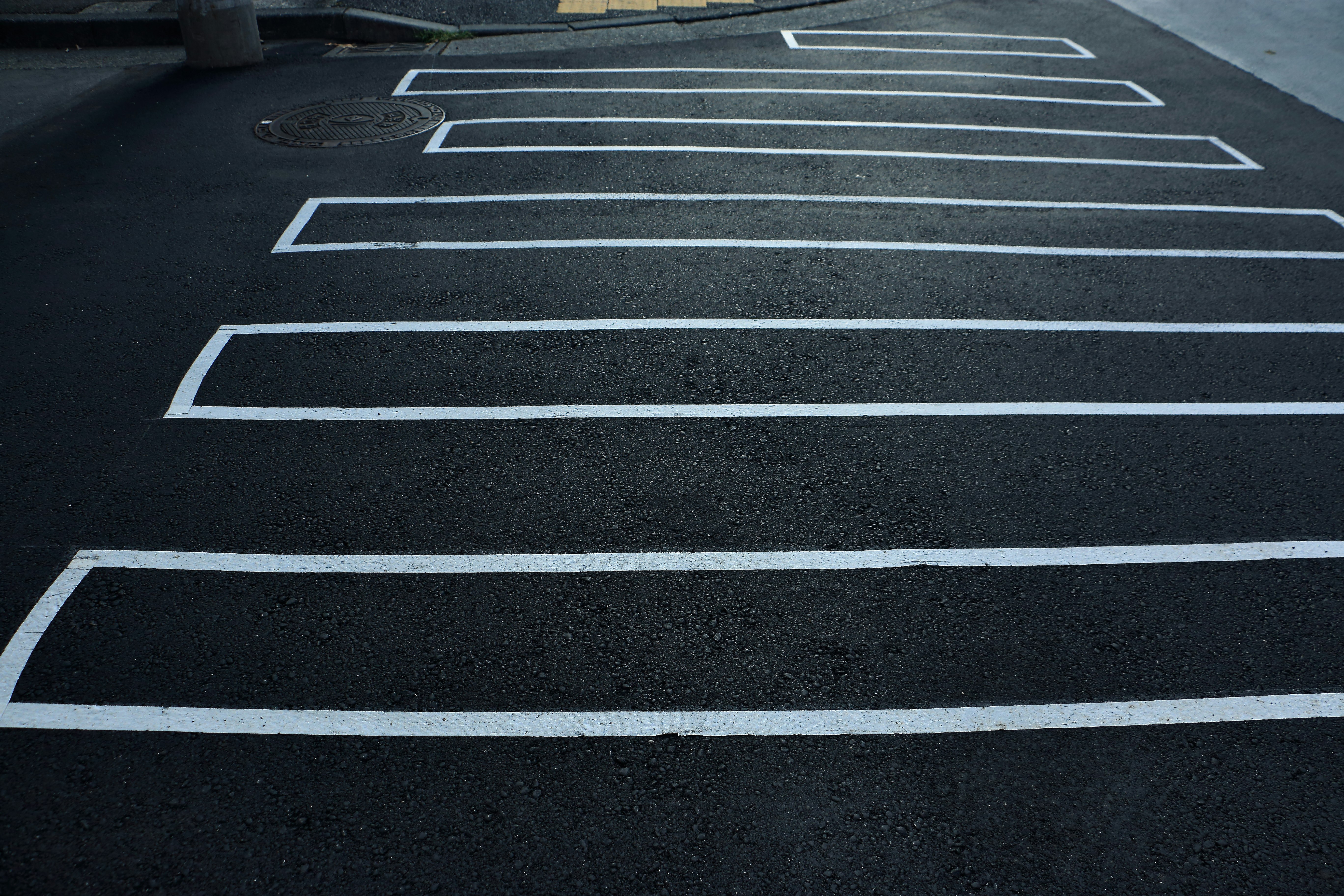 road with painted crosswalk stripes