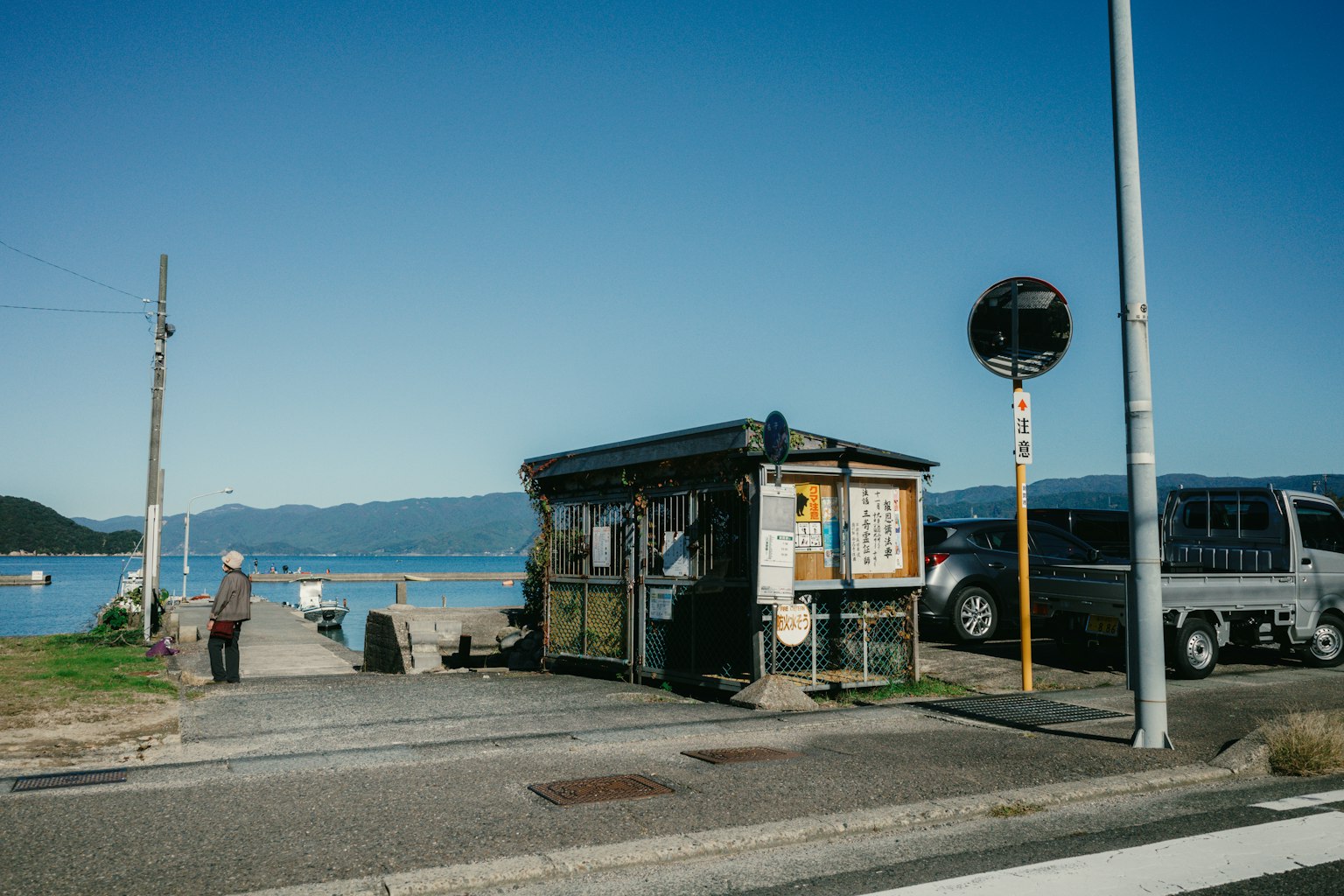 Small bus stop by the seaside with surrounding landscape
