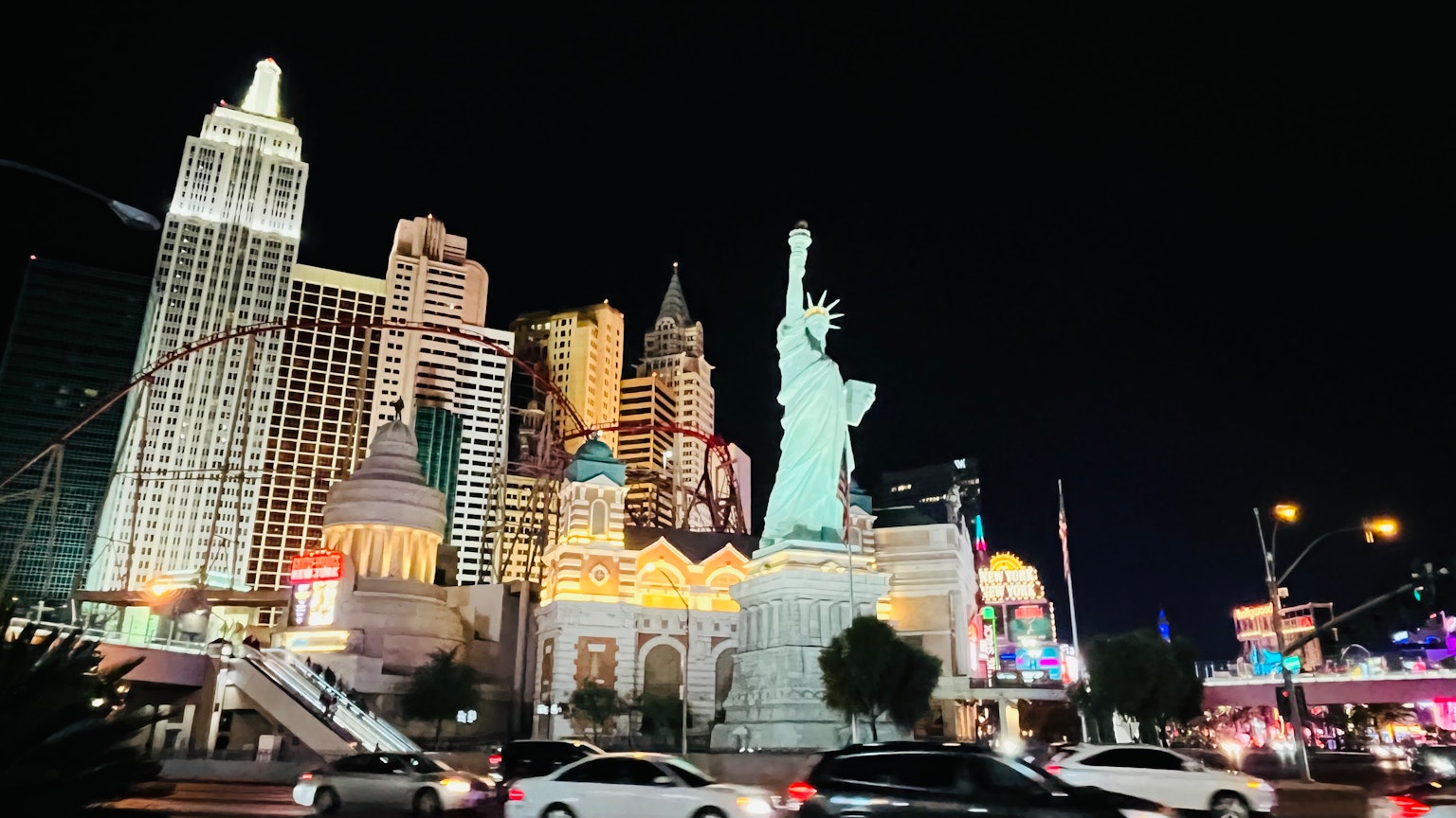 Statue of Liberty at night with Las Vegas skyline and bright casino buildings