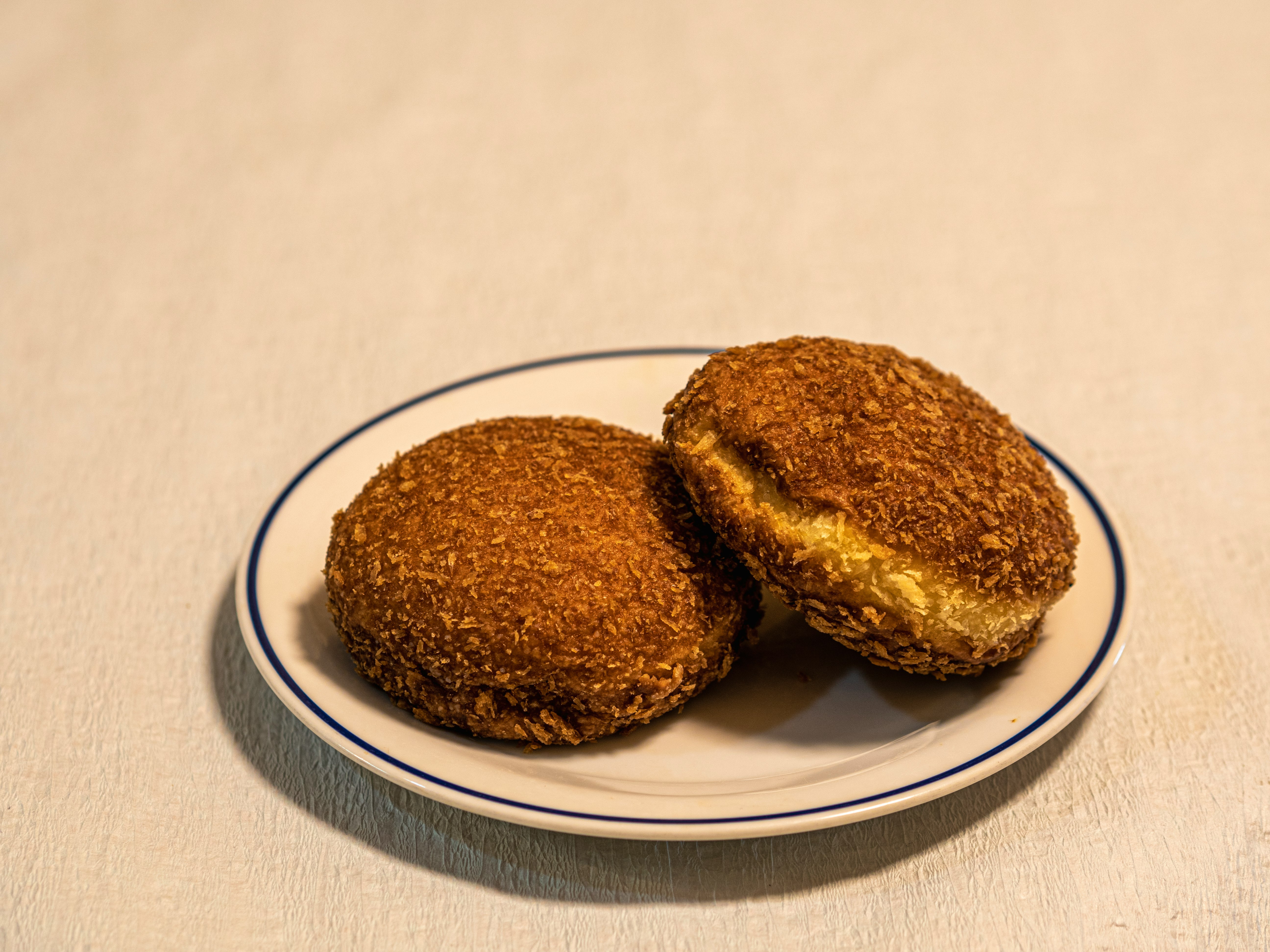 Two fried pastries on a plate