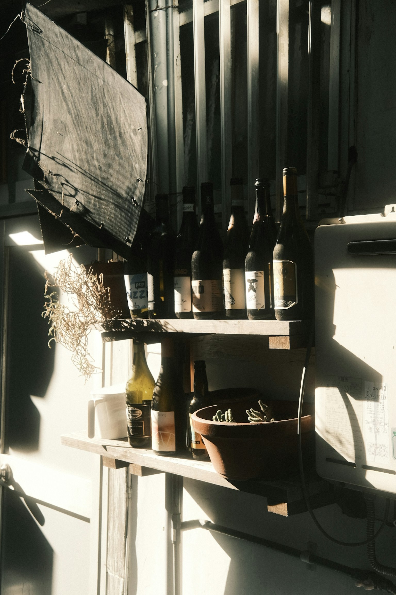 Wooden shelf displaying wine bottles and decorative elements