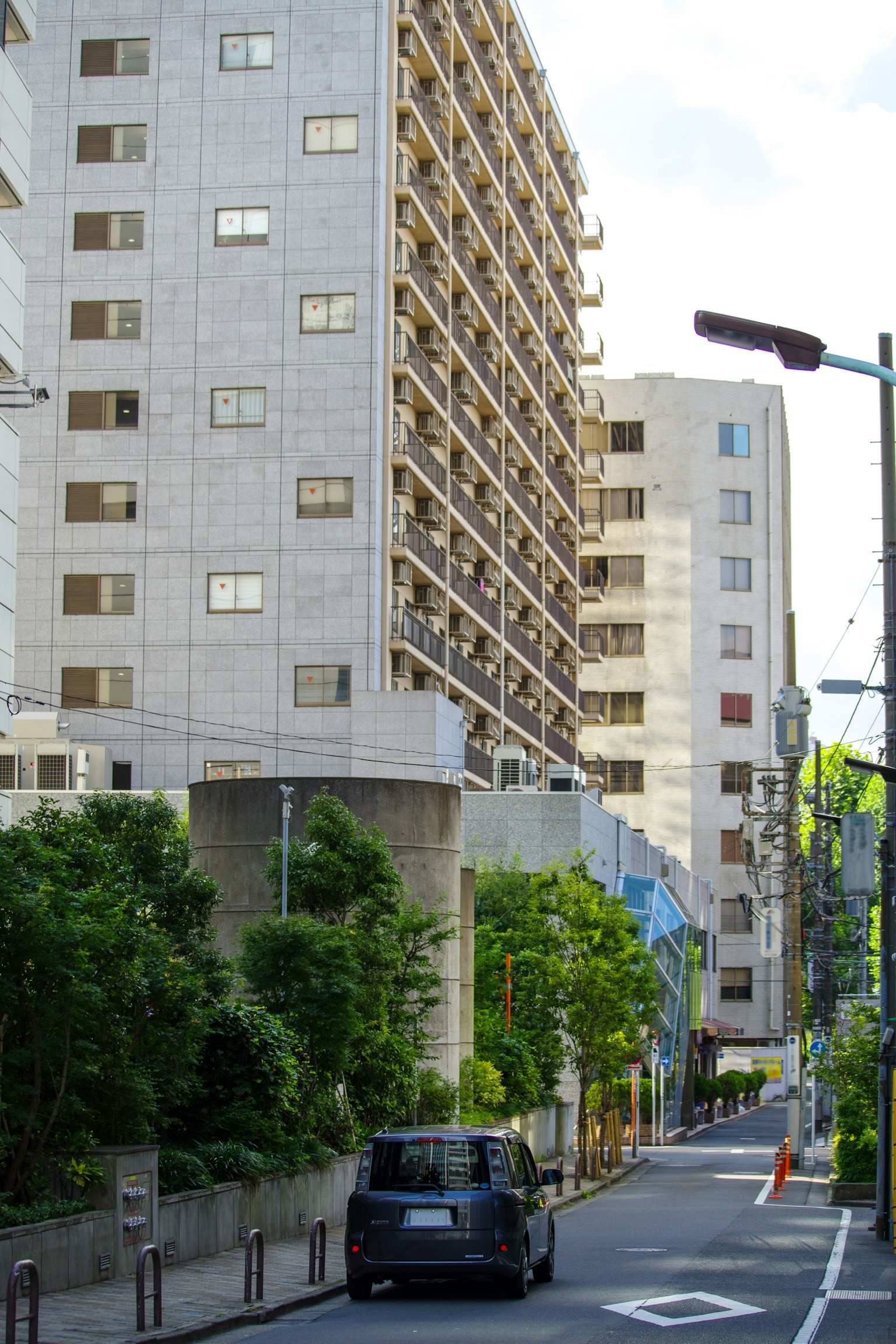 Pemandangan gedung apartemen modern di sepanjang jalan sepi