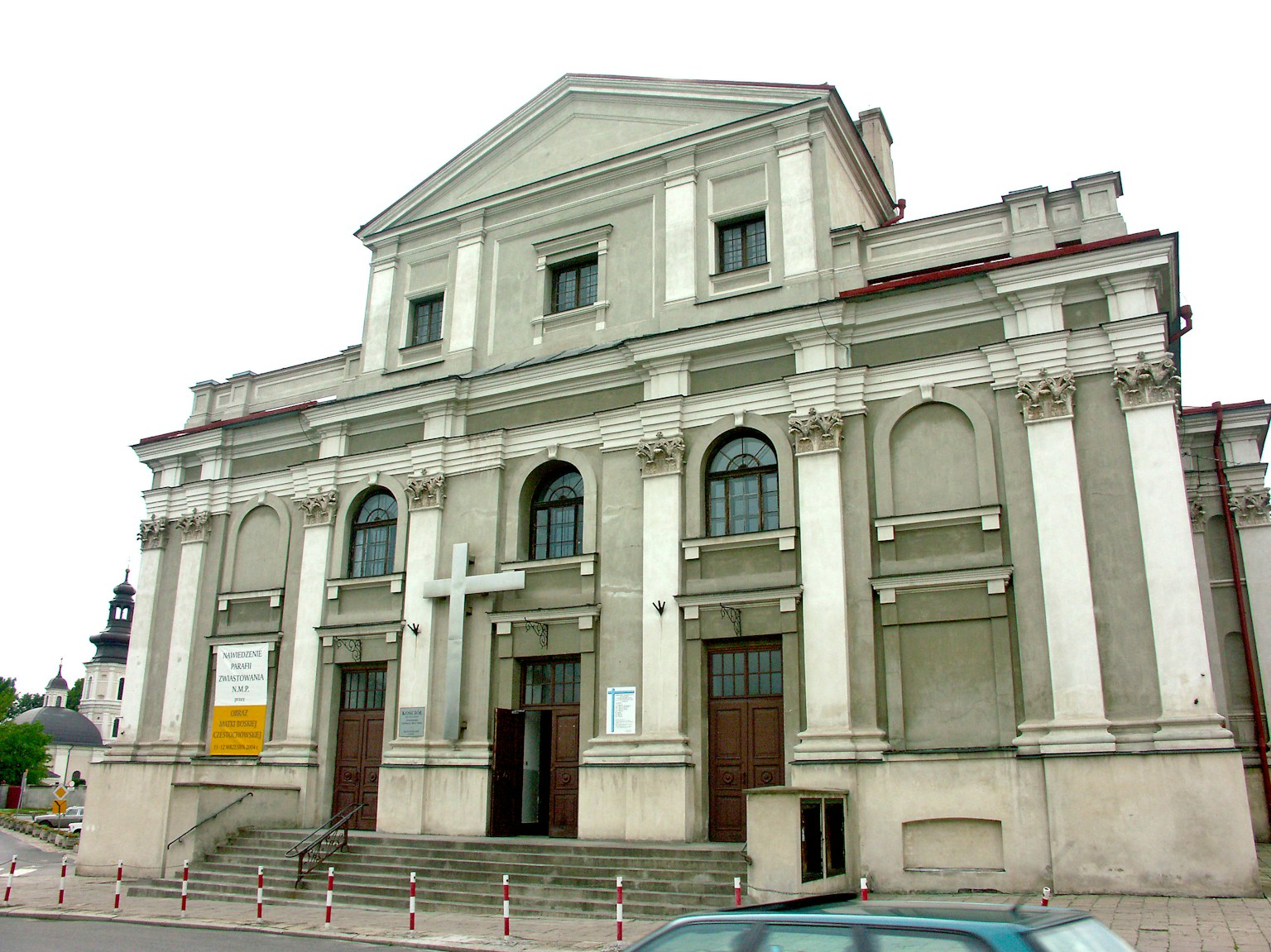 Facade of a classical style church with white walls and decorative columns
