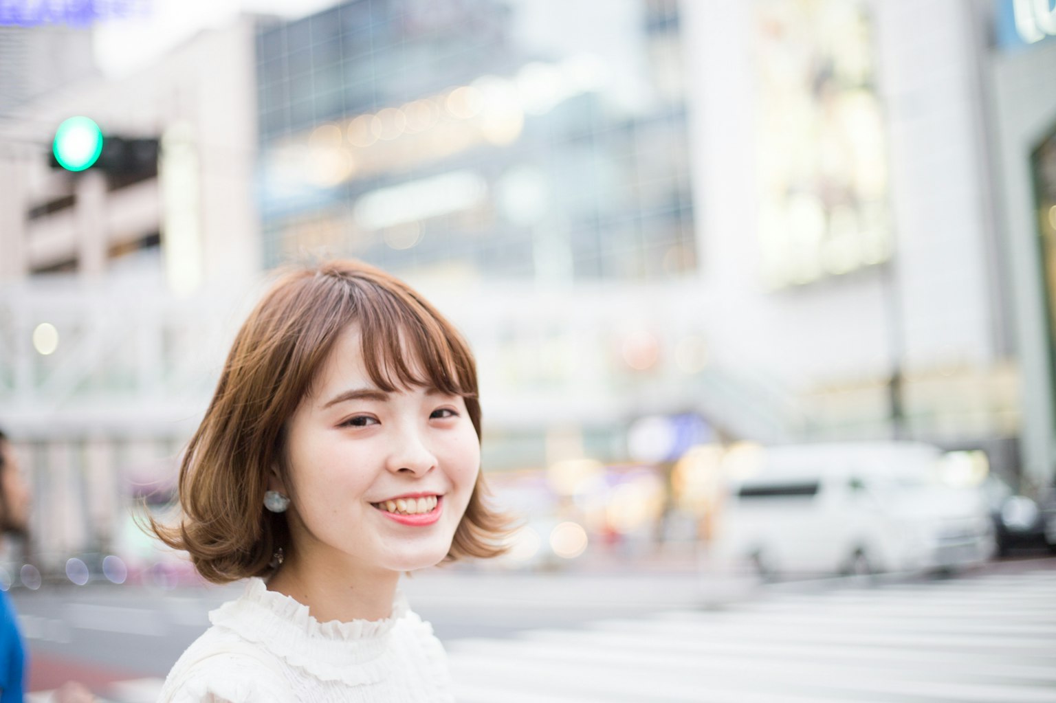 Young woman smiling with a city background