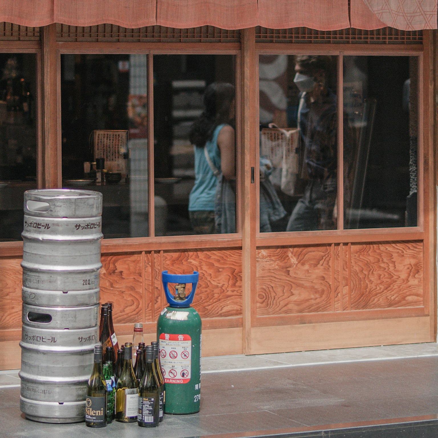 Beverage bottles and gas cylinder outside a shop