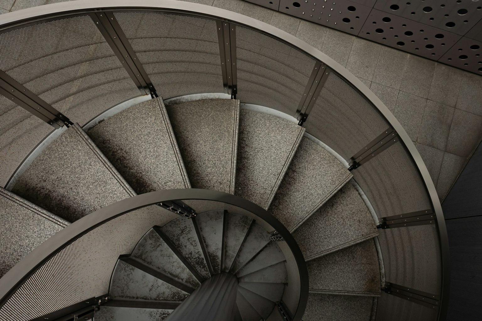 Vue aérienne d'un escalier en spirale avec des marches et des rampes en béton