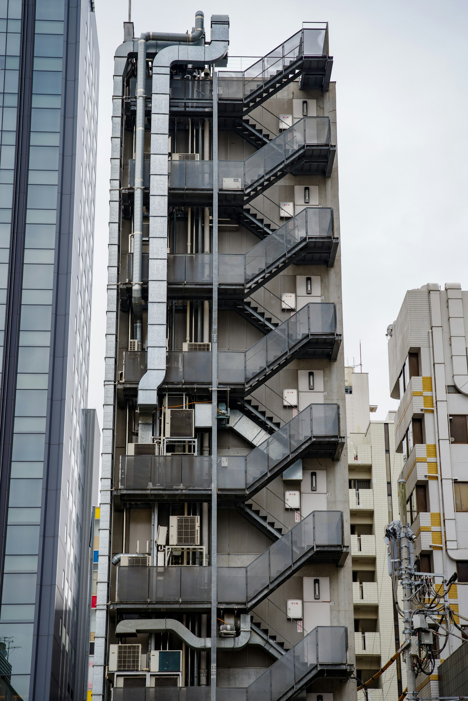 Image of a building featuring an external staircase in a modern urban setting