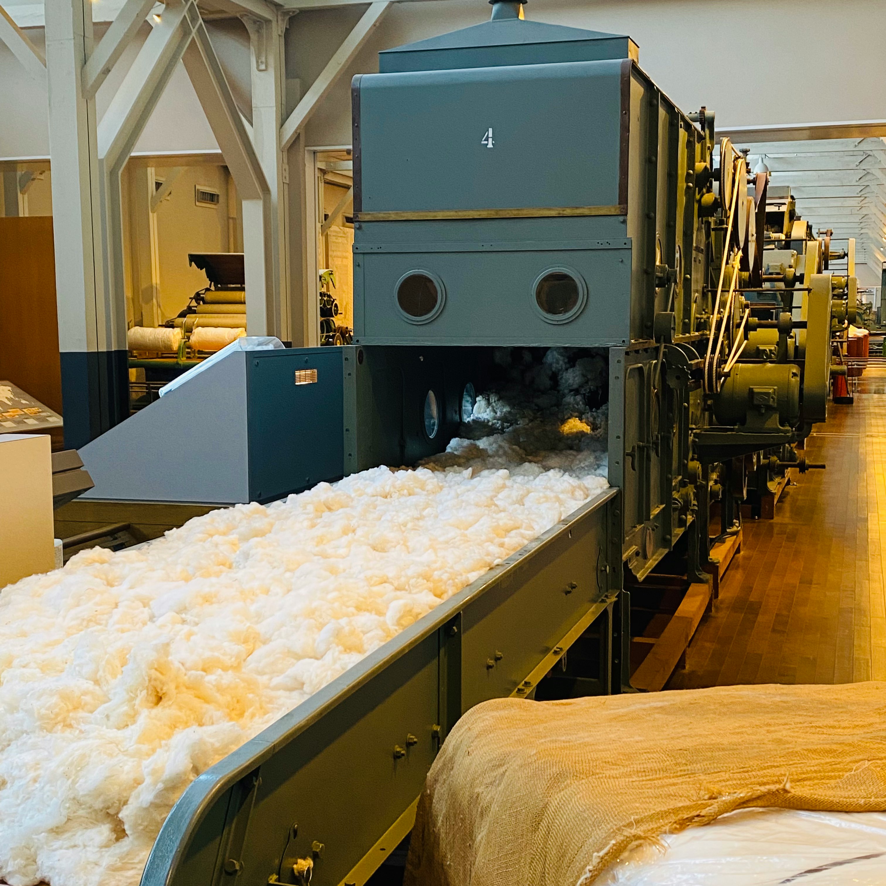 factory production line interior with white material flowing through machinery