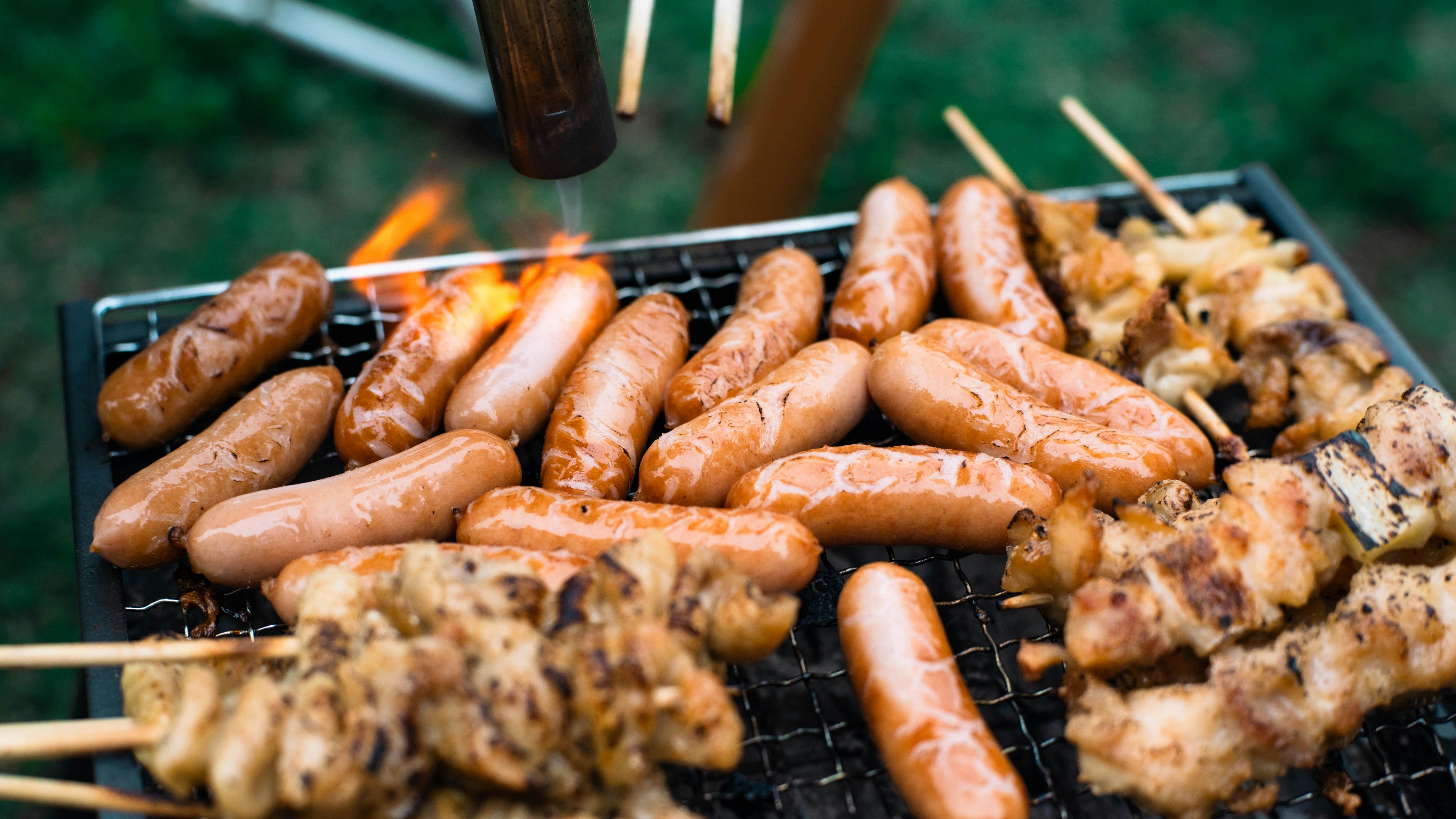 camp barbecue grill with sausages and grilled meat