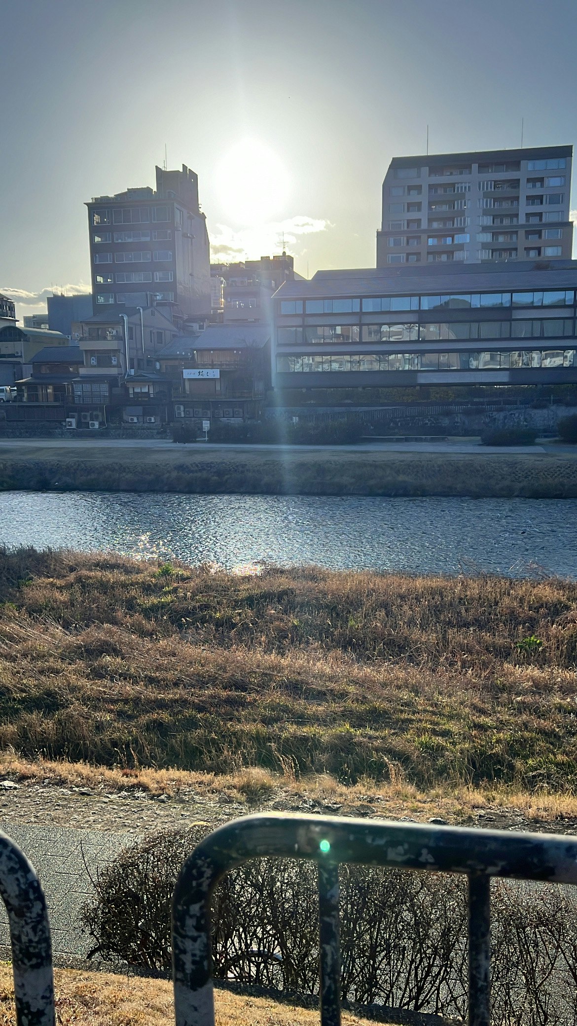 Kyoto Kamo River riverside embankment with sunset light