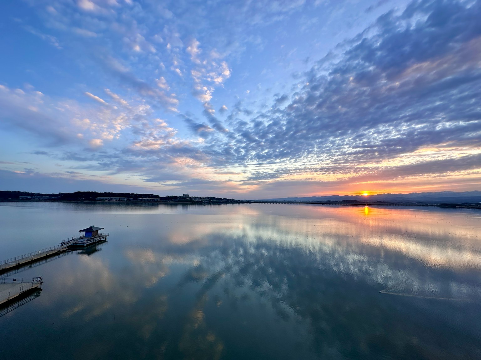 Beautiful sunset over a lake with reflections on the water vibrant colors and cloud patterns visible