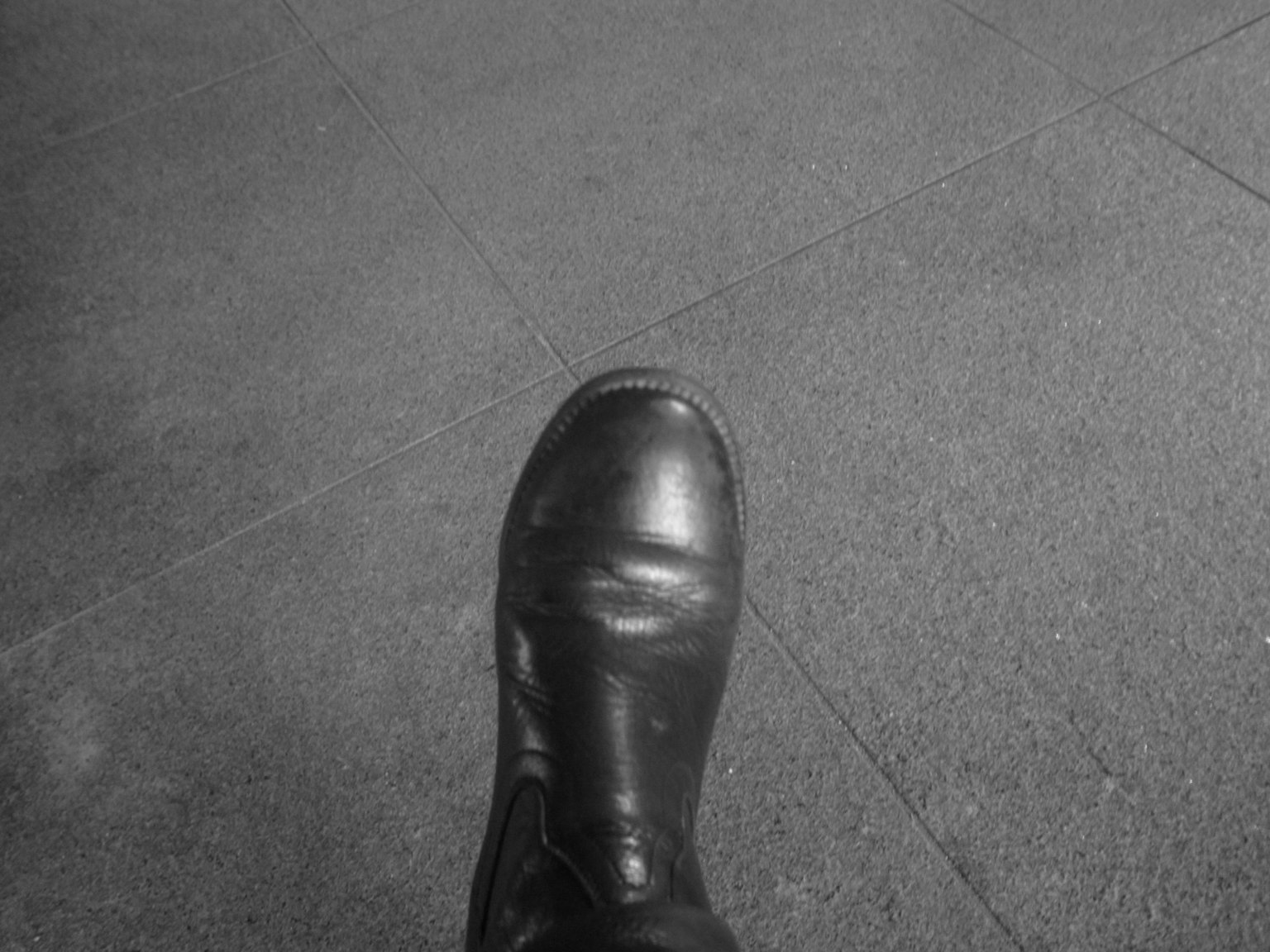 Image of a black boot on a gray surface