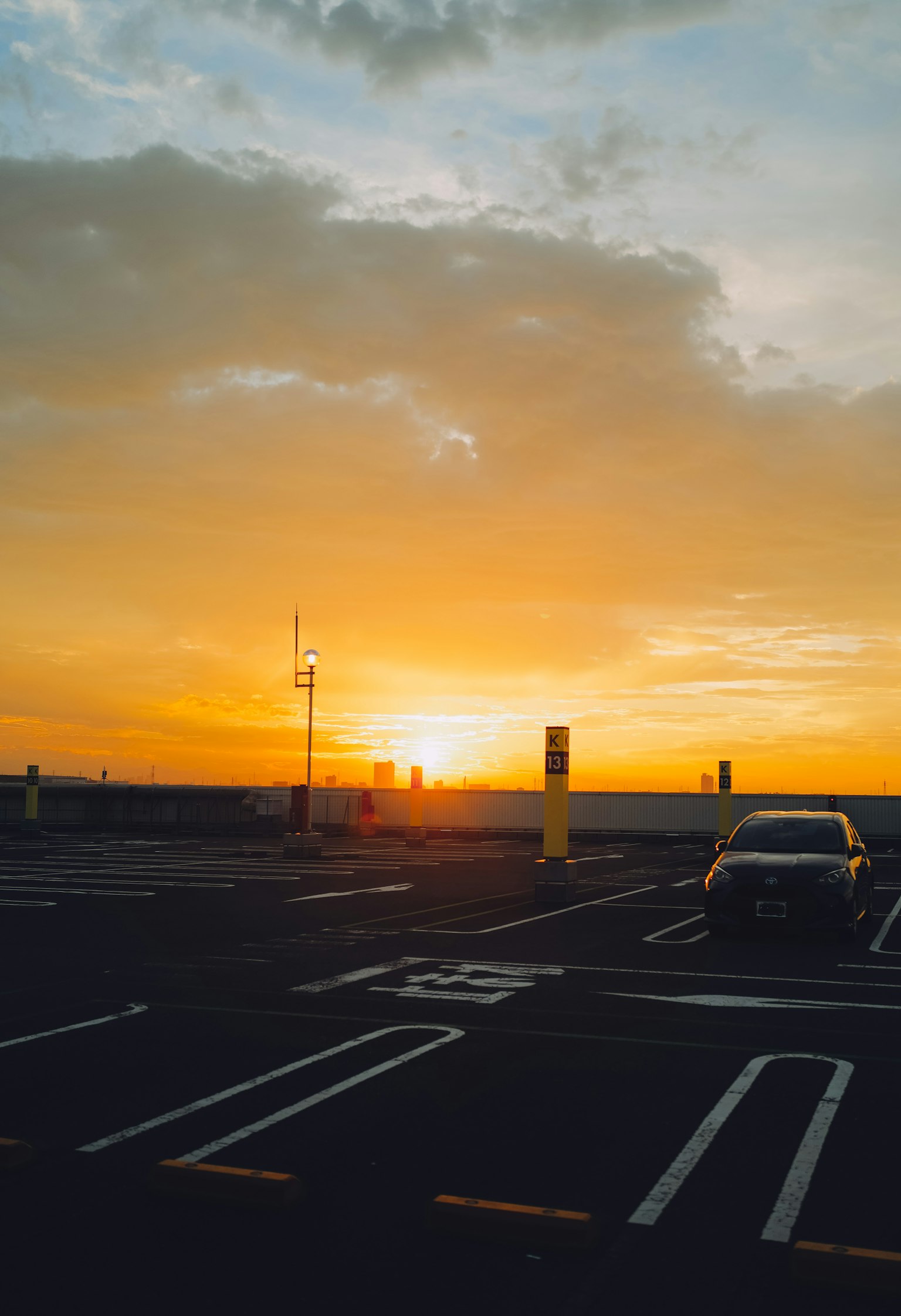 Beautiful sunset and clouds viewed from a parking lot