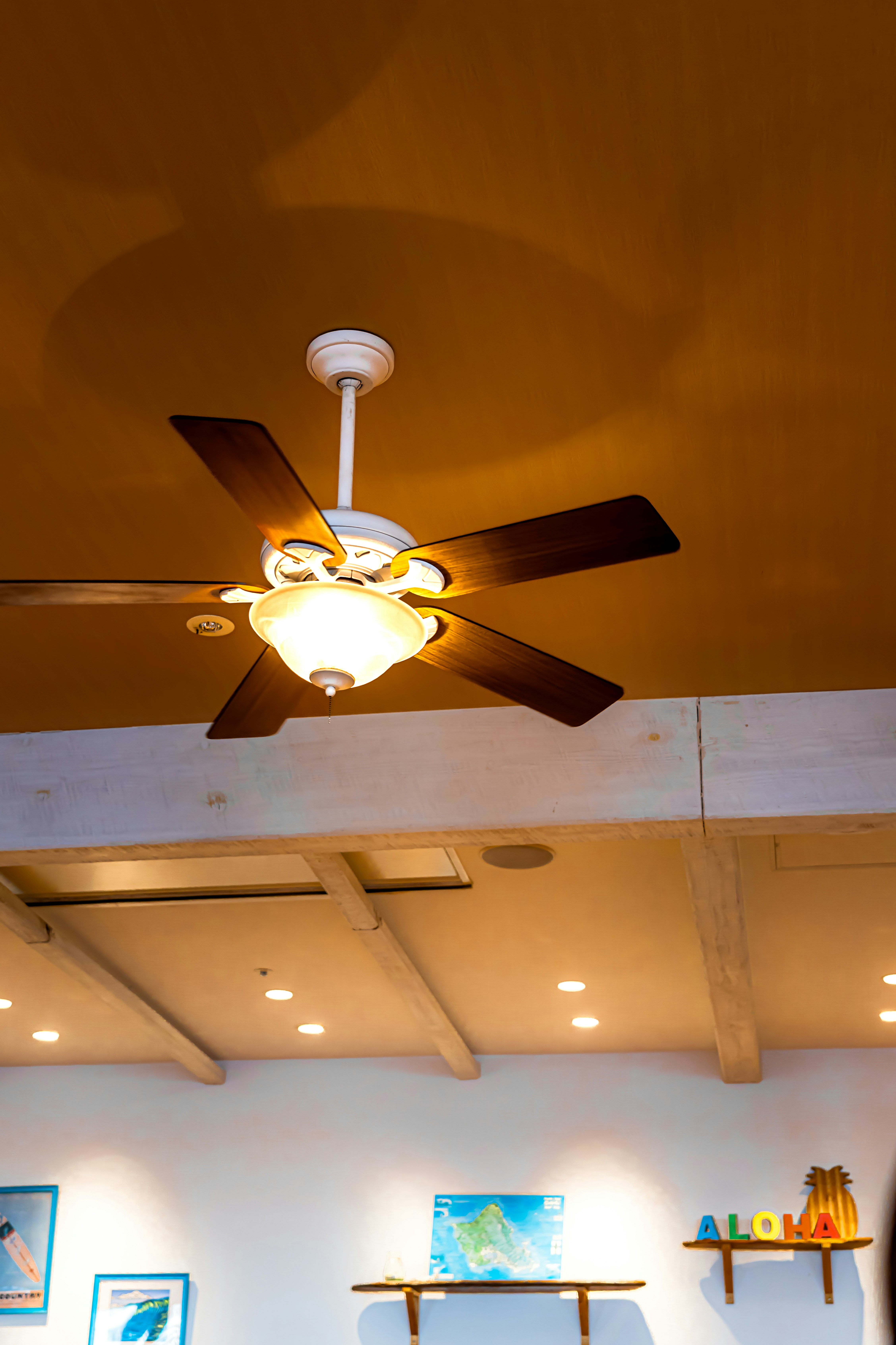 ceiling fan and warm indoor lighting in a cafe interior