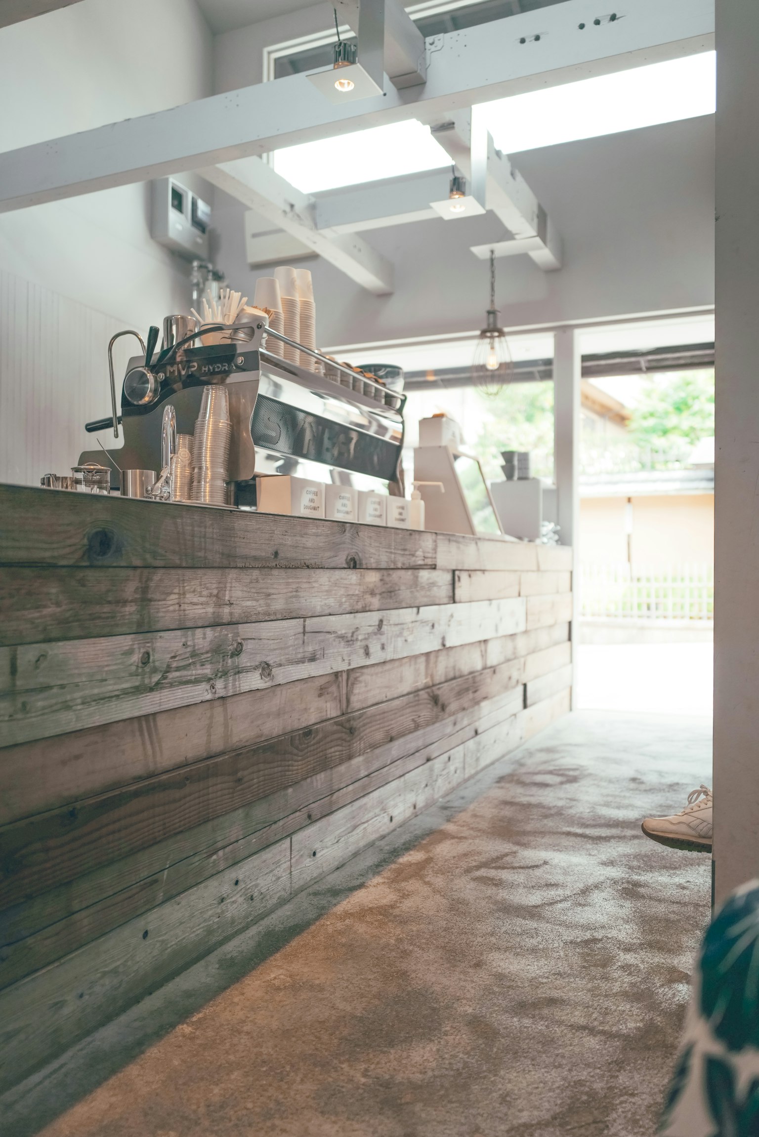 Interior of a café featuring a wooden counter and bright windows